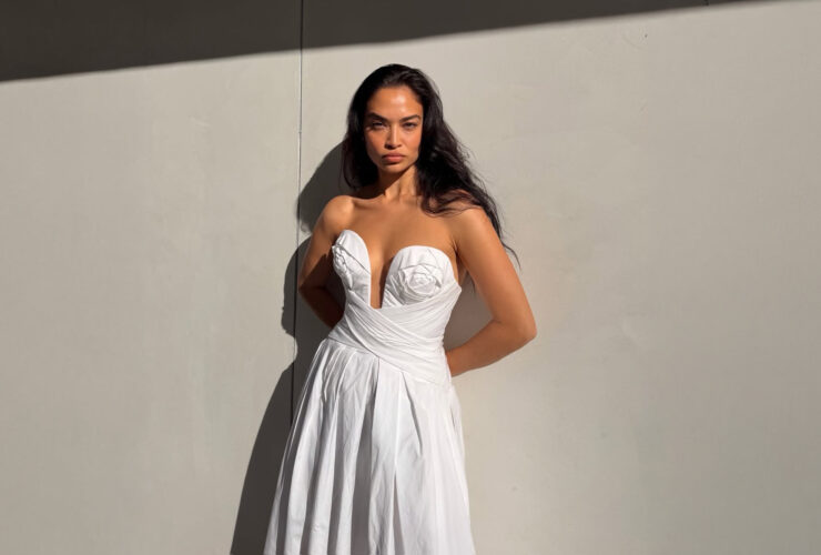 Shanina Shaik wearing a white strapless draped A line midi dress from Carolina Herrera Resort 2026