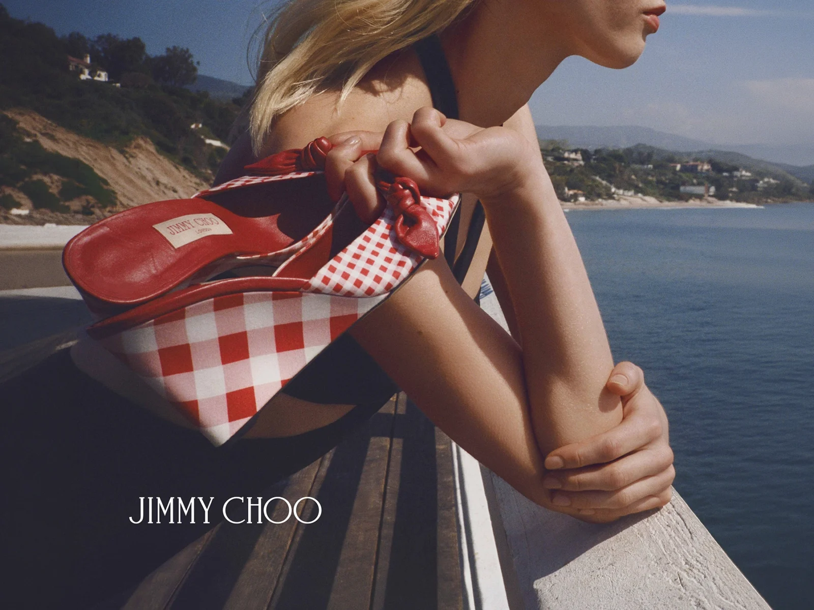 Jimmy Choo Riviera 2026 campaign featuring raffia and gingham accessories in a Malibu setting