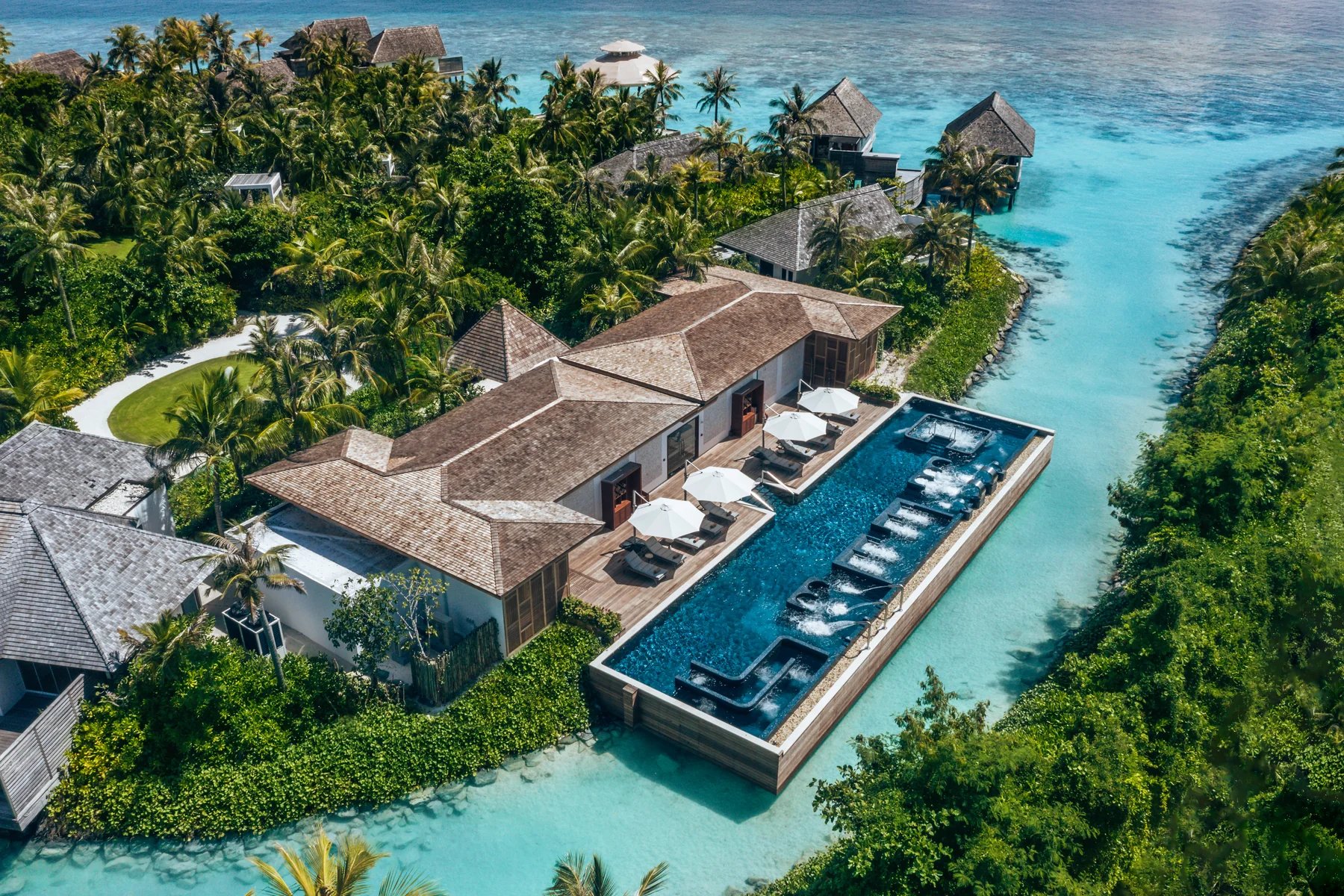 Aerial view of the Aqua Wellness Centre over the lagoon at Waldorf Astoria Maldives Ithaafushi