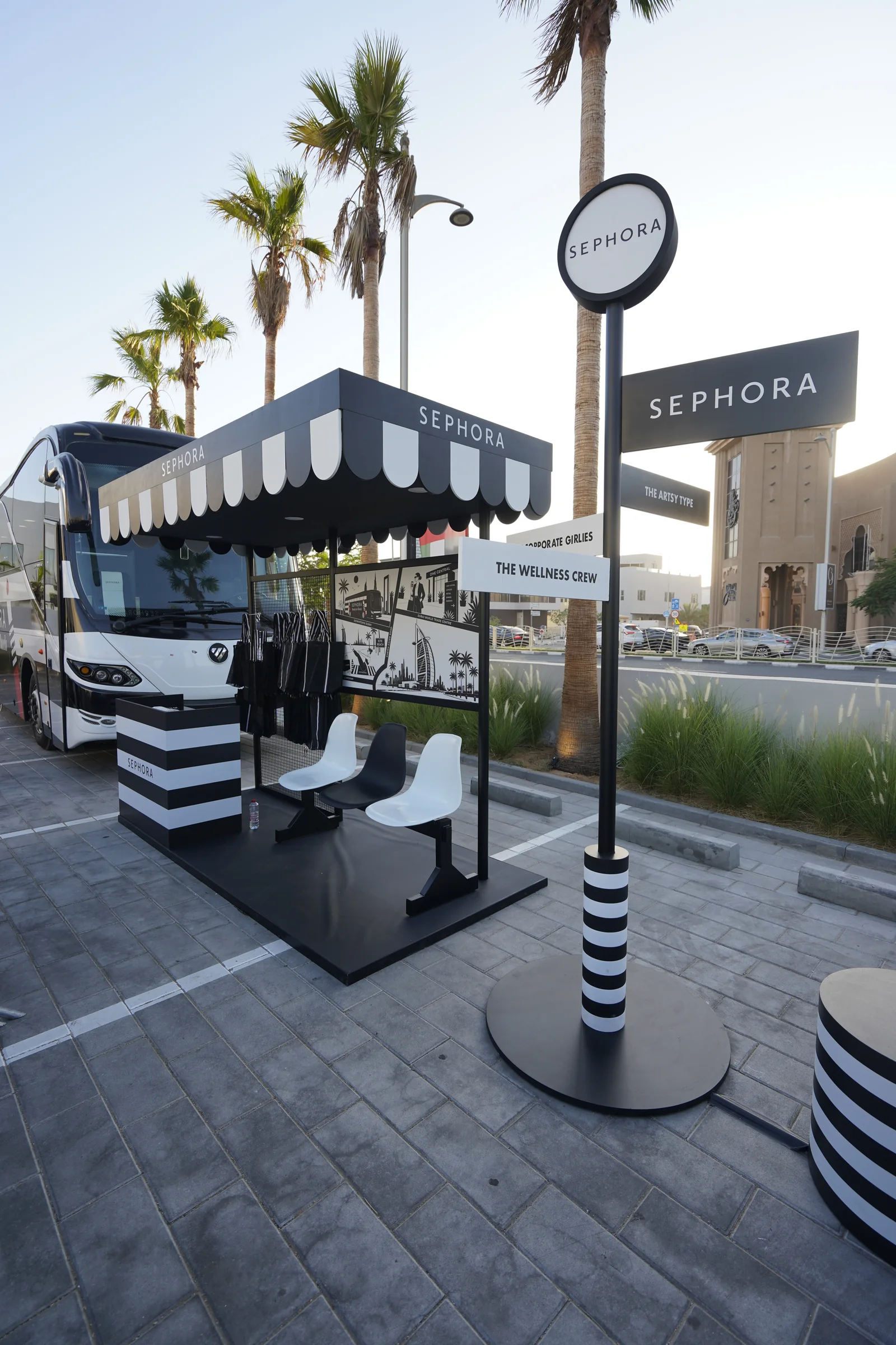Sephora Beauty Bus activation in Dubai with striped awning, seating and a round Sephora sign
