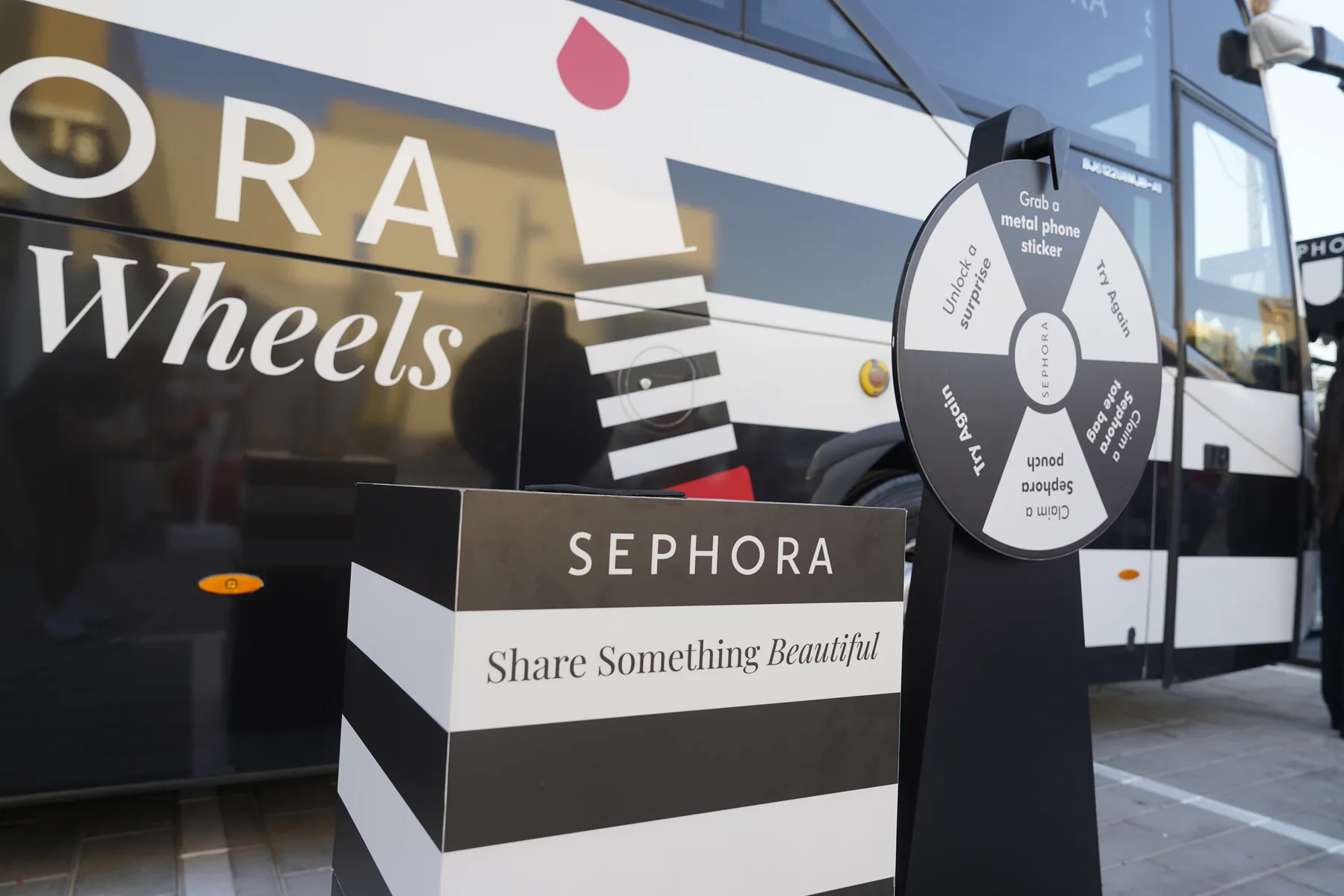 Sephora Share Something Beautiful prize wheel and lipstick display on the Beauty on Wheels bus