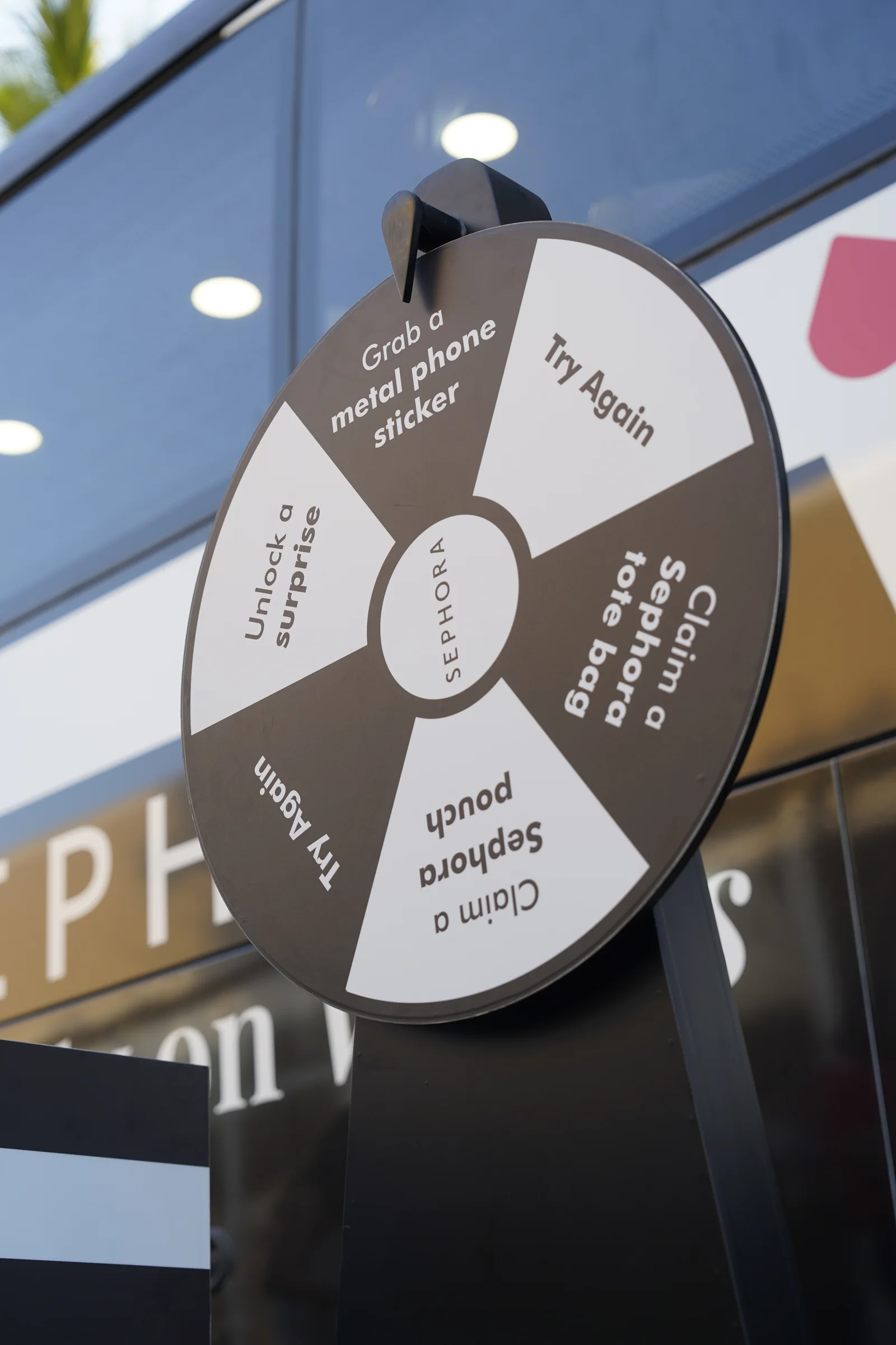 Sephora prize wheel giveaway game offering a tote bag, pouch and surprises on the Beauty Bus
