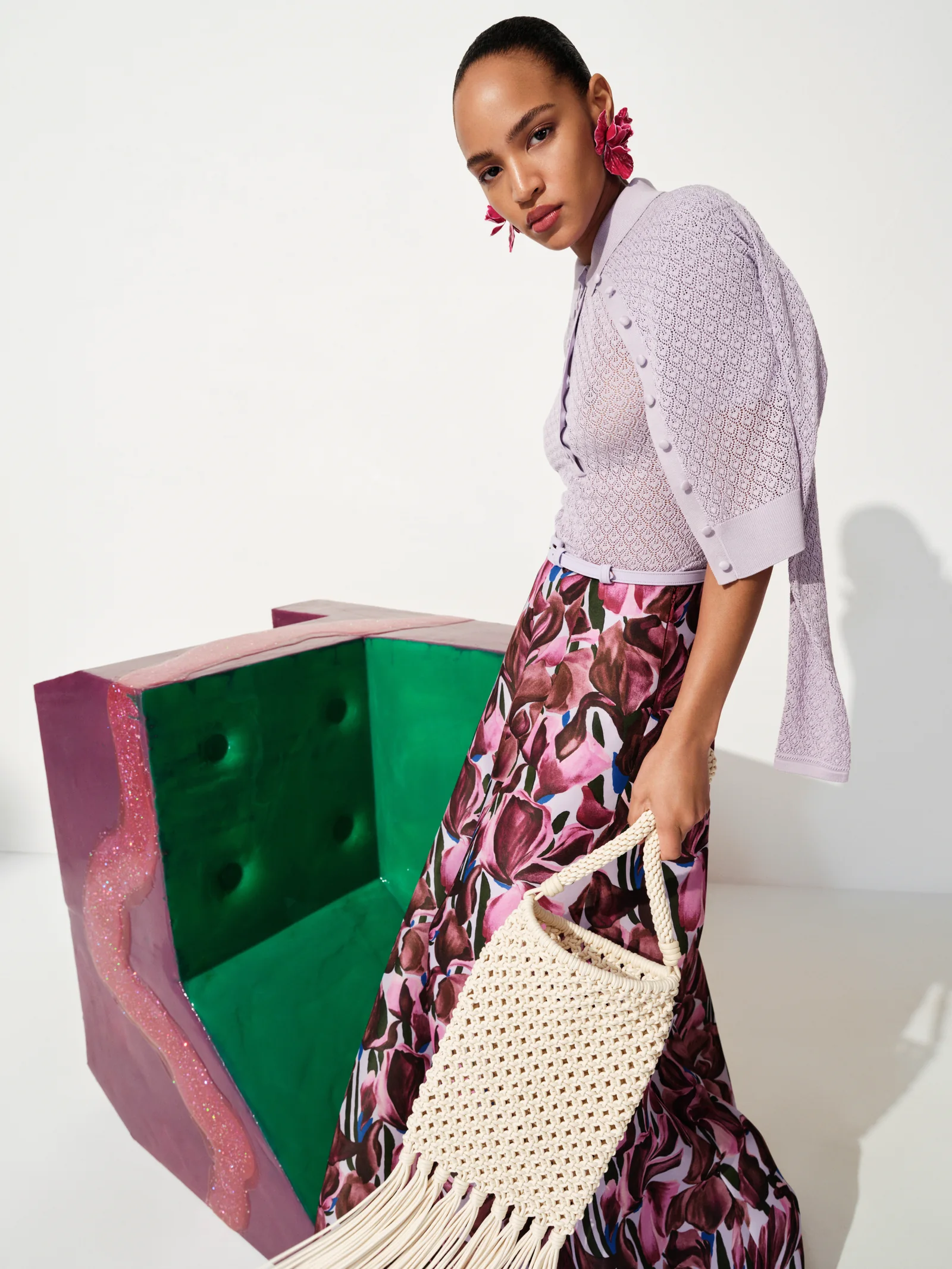 Lilac cardigan and tulip print skirt with macrame bag from Carolina Herrera Resort 2027