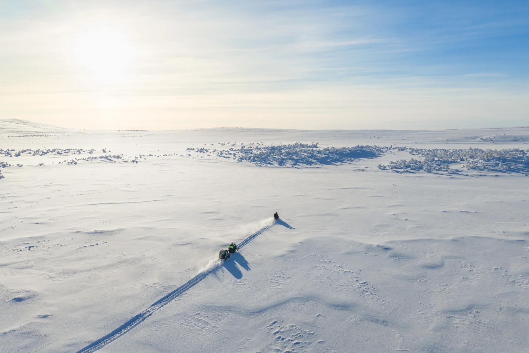 A snowmobile on the snowfields of Octola Private Wilderness in Finnish Lapland