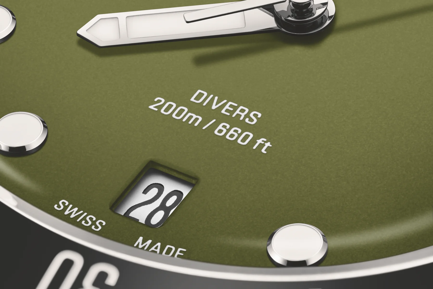 Macro of the Oris Divers Date olive green dial showing the date window and Swiss Made text