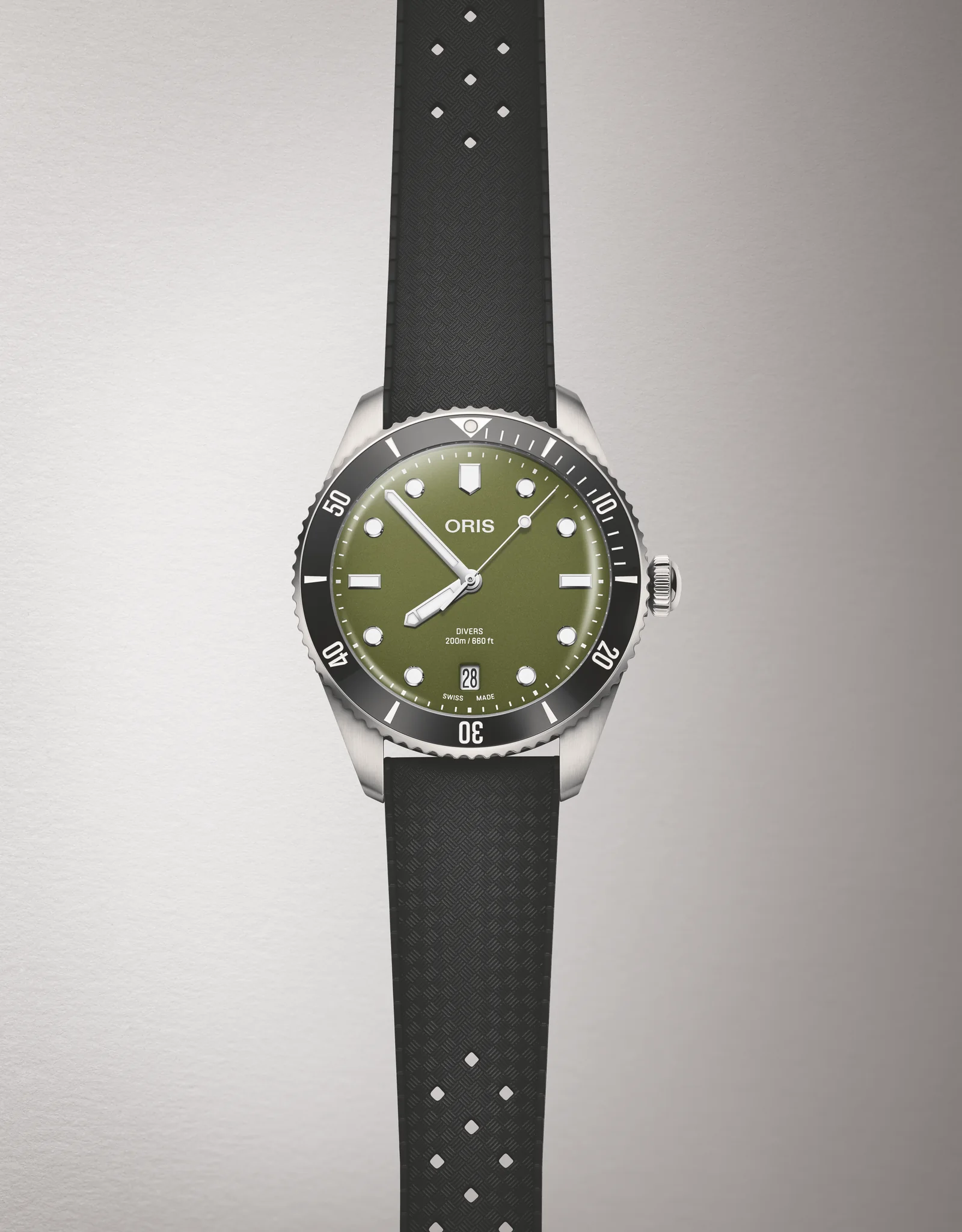 Oris Divers Date olive green on a rubber strap against a neutral background