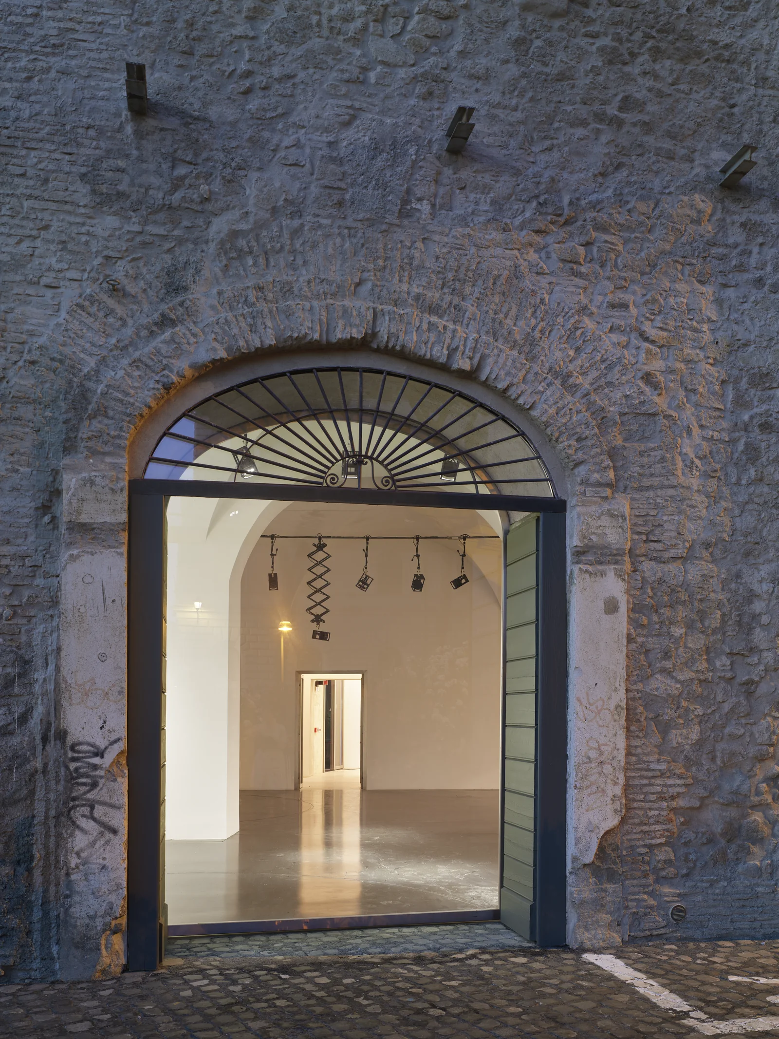 An ancient arch opening into the white gallery at rhinoceros roma