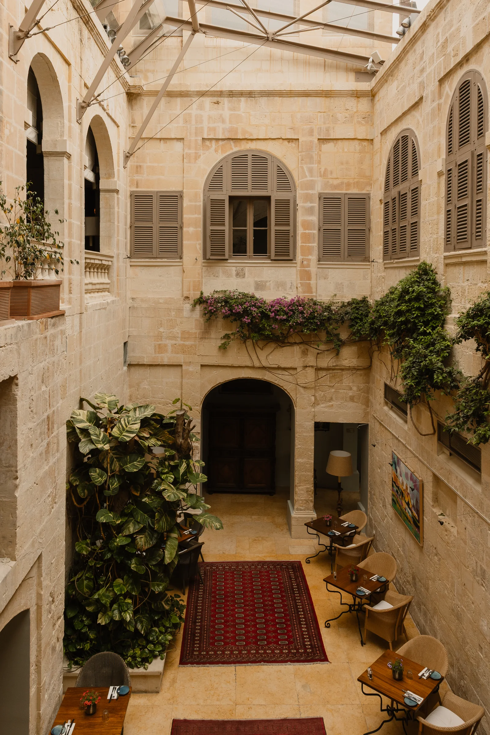 The arched stone courtyard of The Xara Palace in Mdina