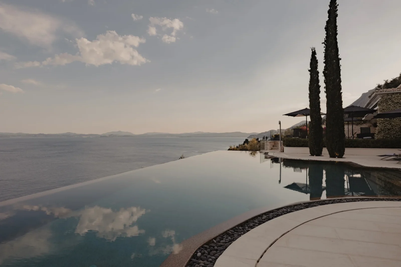 The infinity pool at Ultima Corfu at dusk, part of the ALS Private portfolio