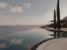 The infinity pool at Ultima Corfu at dusk, part of the ALS Private portfolio