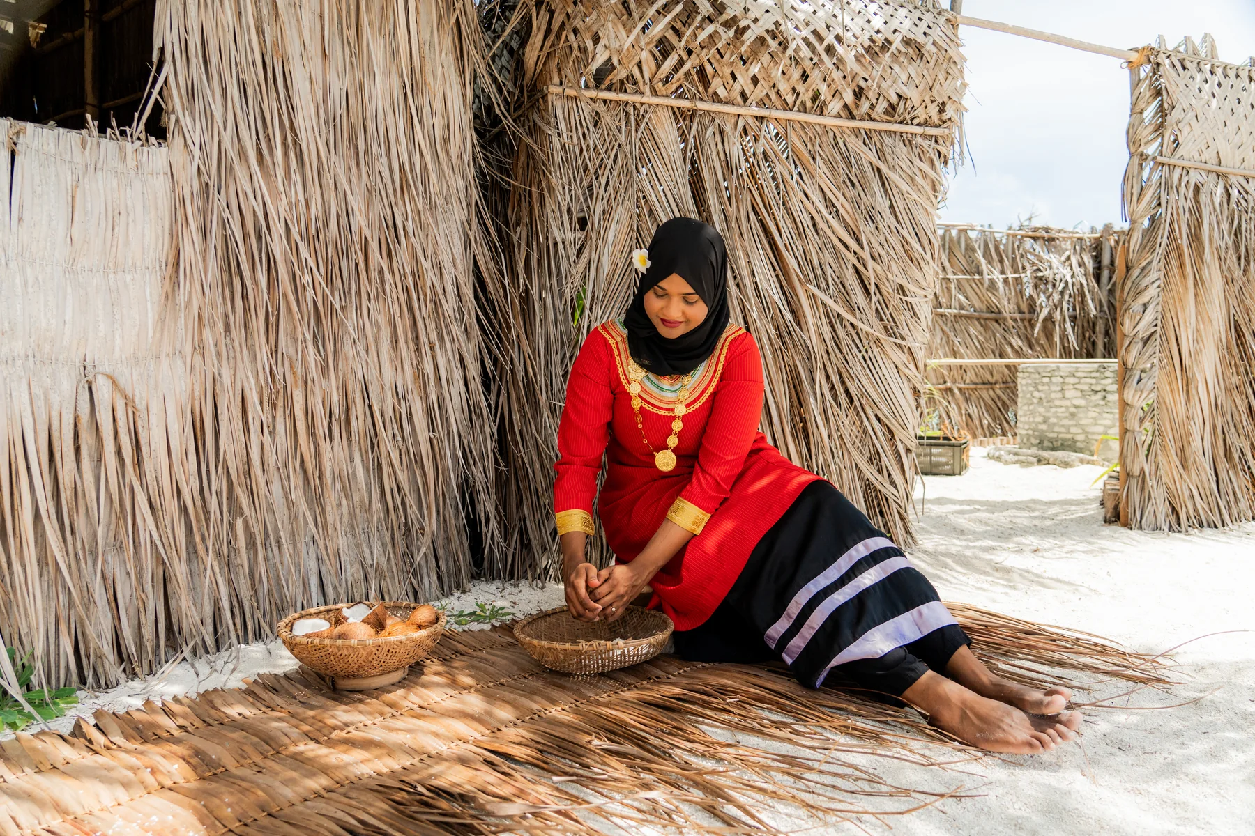 Hand husking coconuts during a Maldivian Roots session at Sun Siyam Vilu Reef
