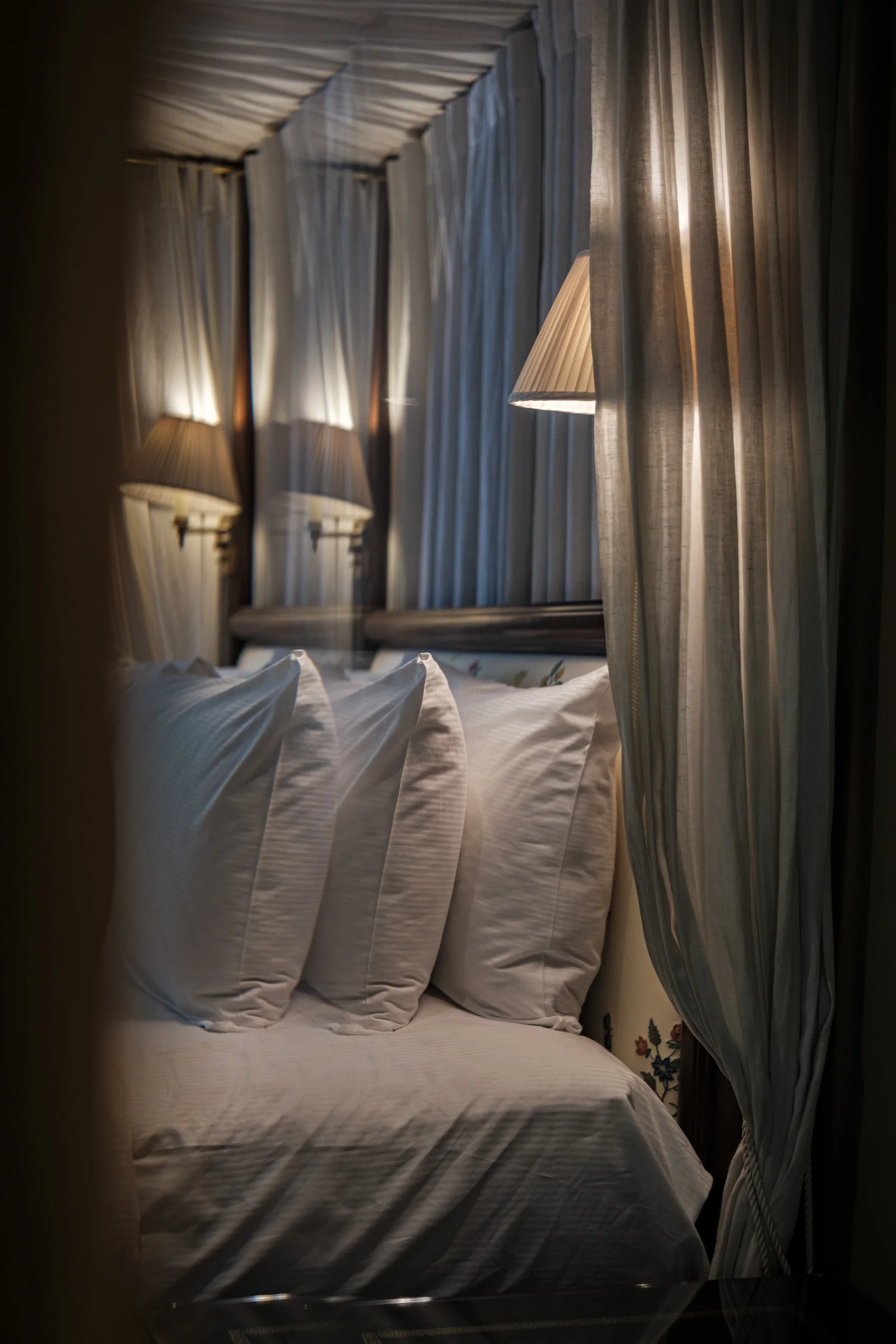 The draped canopy of a four-poster bed at Roseate House London