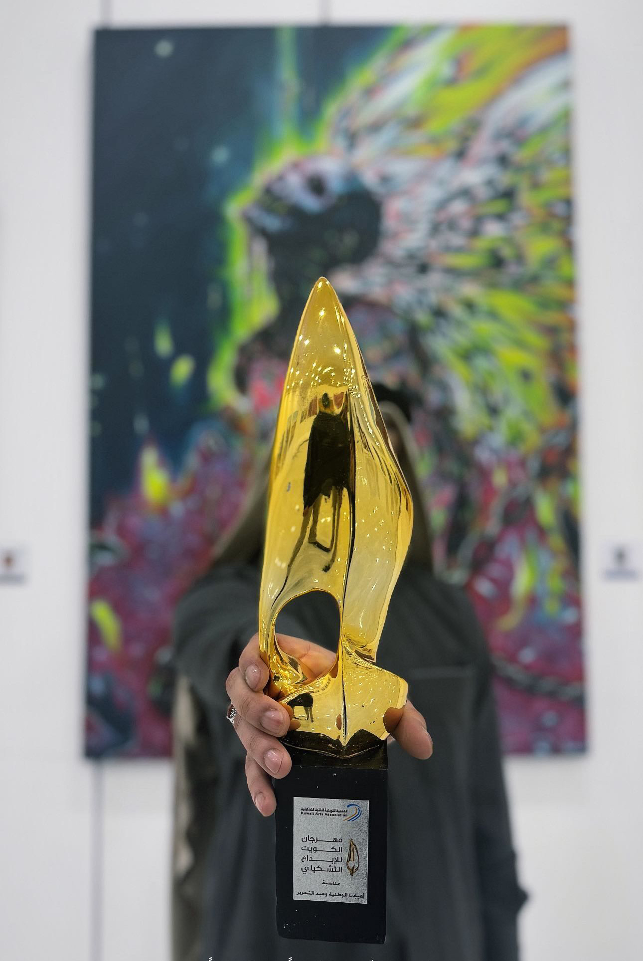 Ahmad Alhussaini with one of his paintings