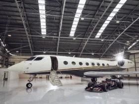 Flexjet Gulfstream private jet parked beside a Formula 1 car, marking the 2026 Flexjet Formula 1 Official Private Aviation Supplier partnership