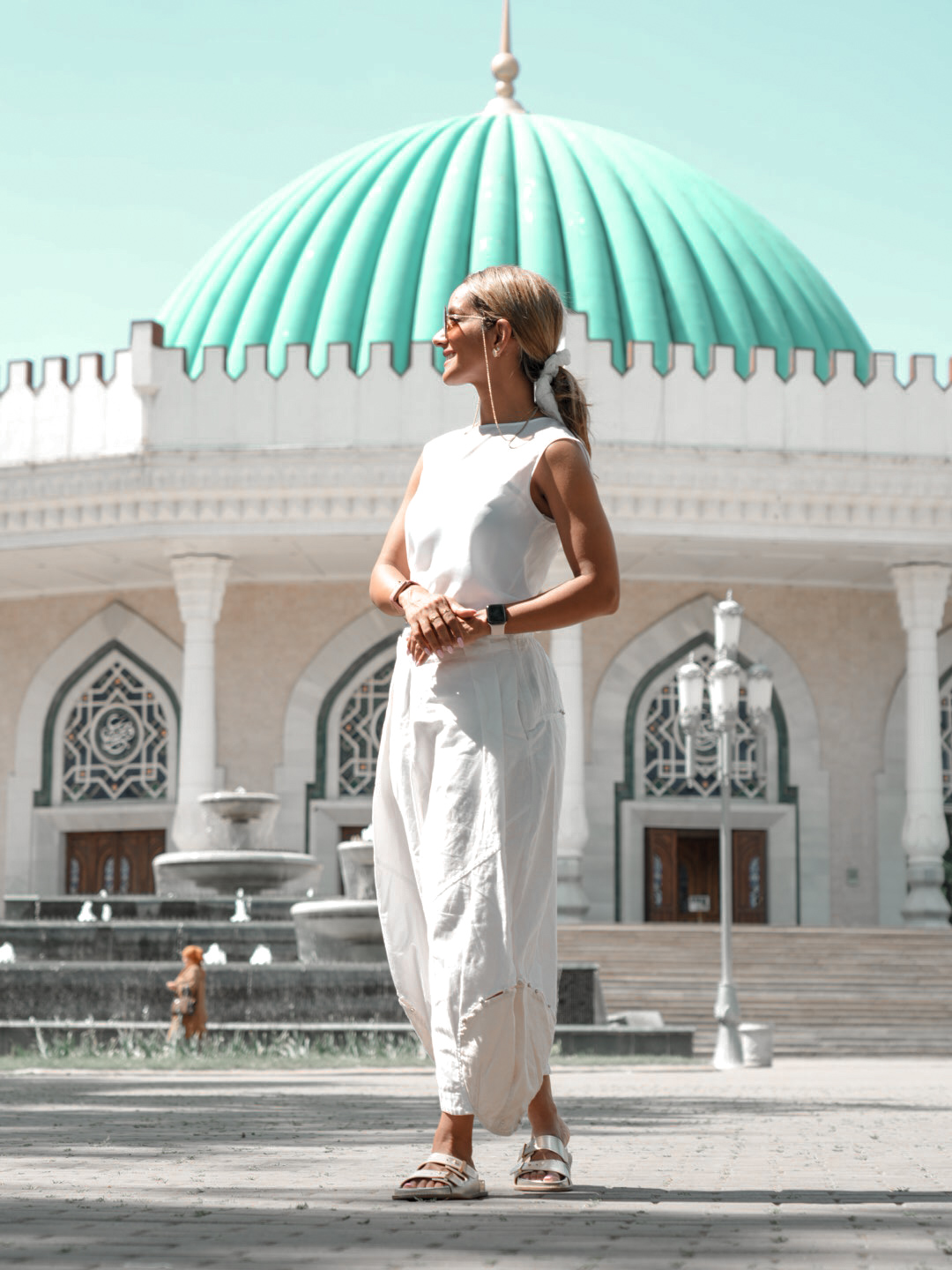 Fatima AlMattar in white before arabesque arches