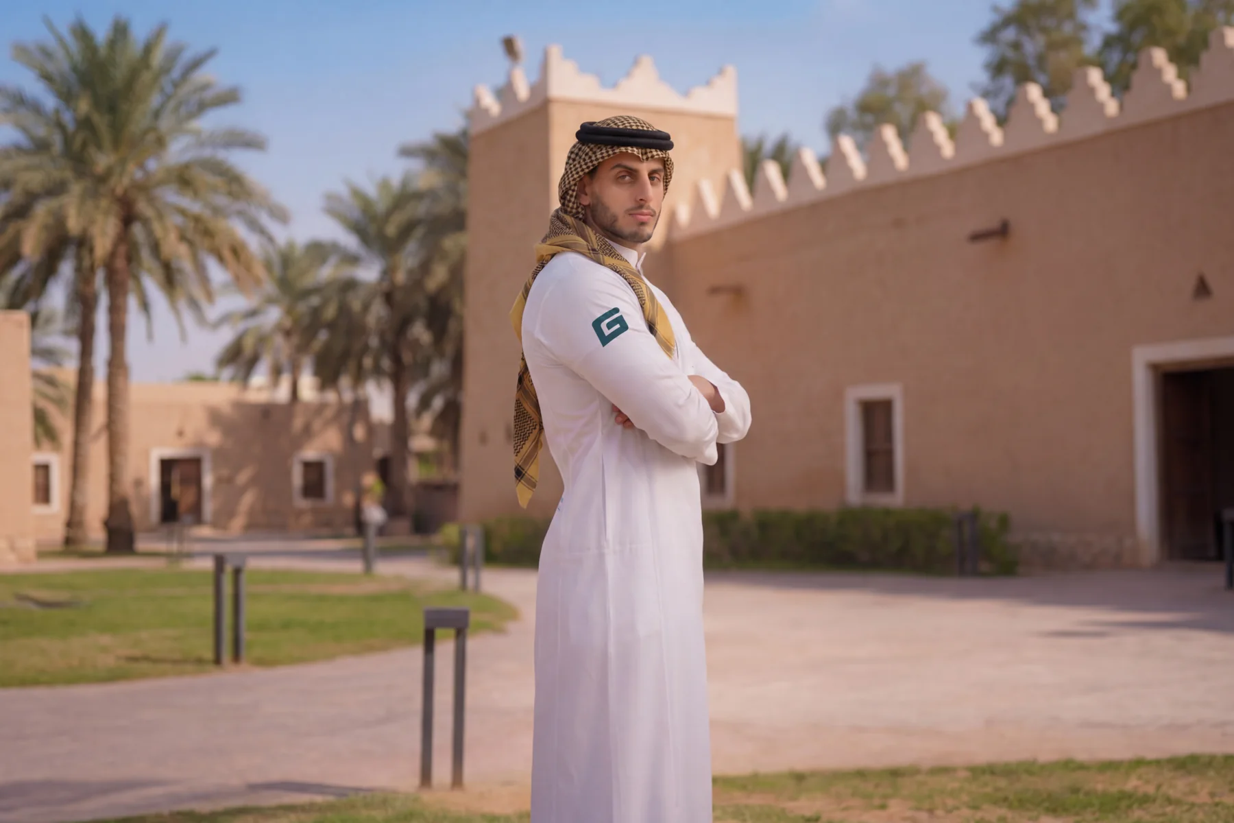 A GymNation Muscle Thobe worn against a Saudi heritage backdrop