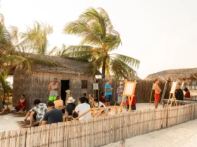 Guests gathering at the Athireege cultural village at sunset, Sun Siyam Vilu Reef Maldives