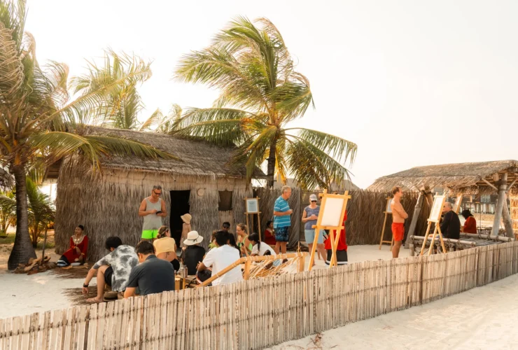 Guests gathering at the Athireege cultural village at sunset, Sun Siyam Vilu Reef Maldives