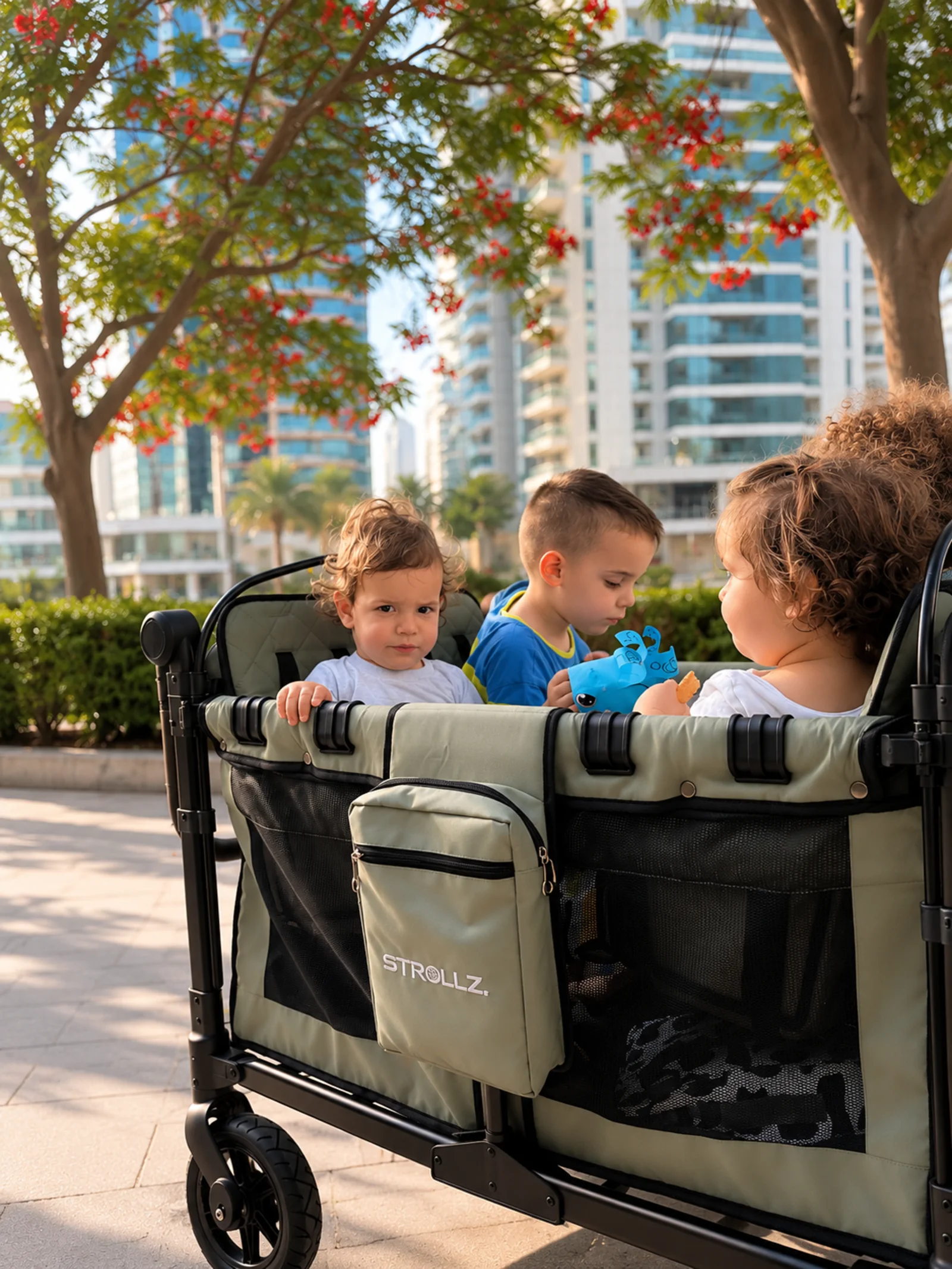 Children seated in the STROLLZ. four-seater stroller wagon