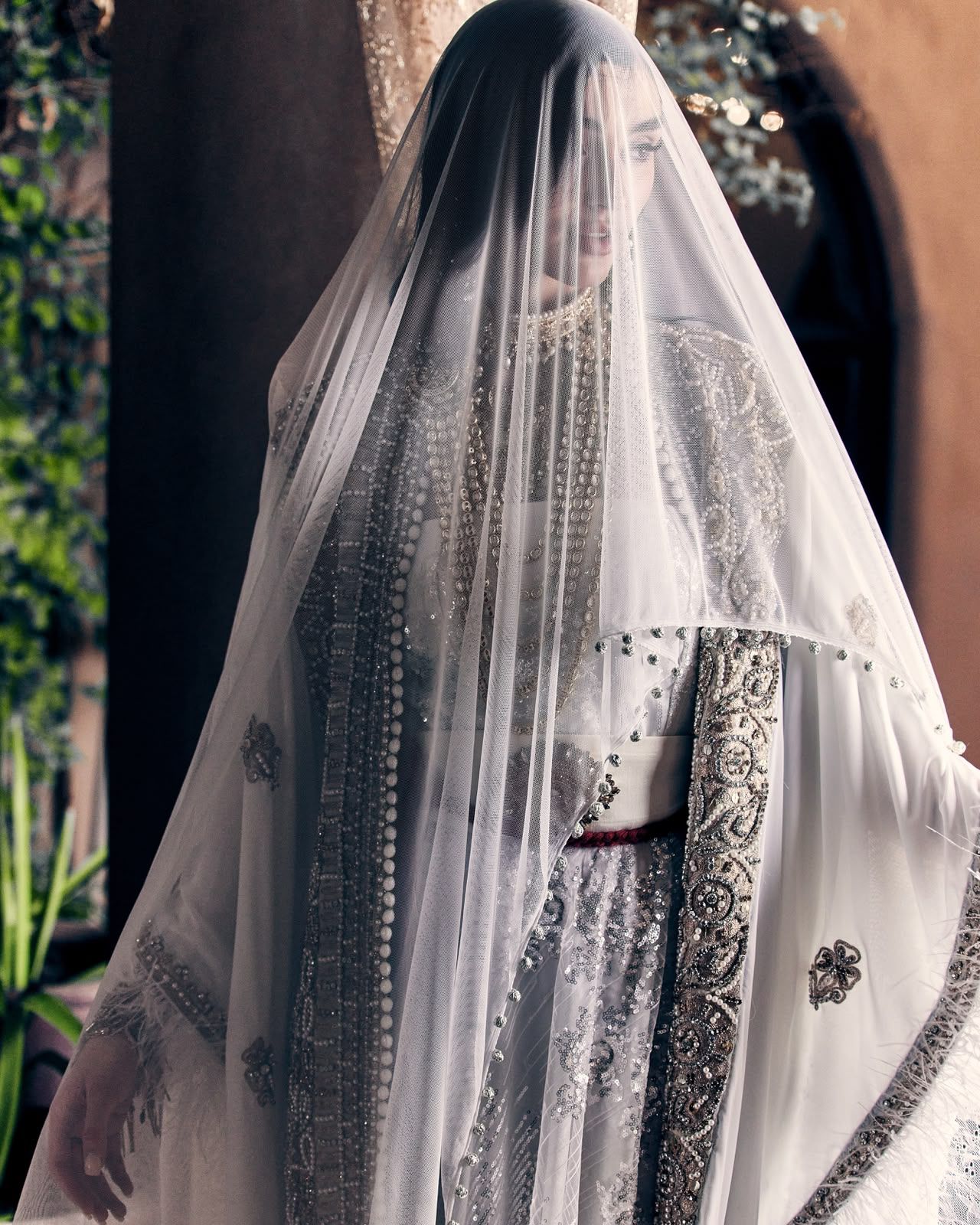Detail of a sheer, finely embroidered Muhra veil in ivory