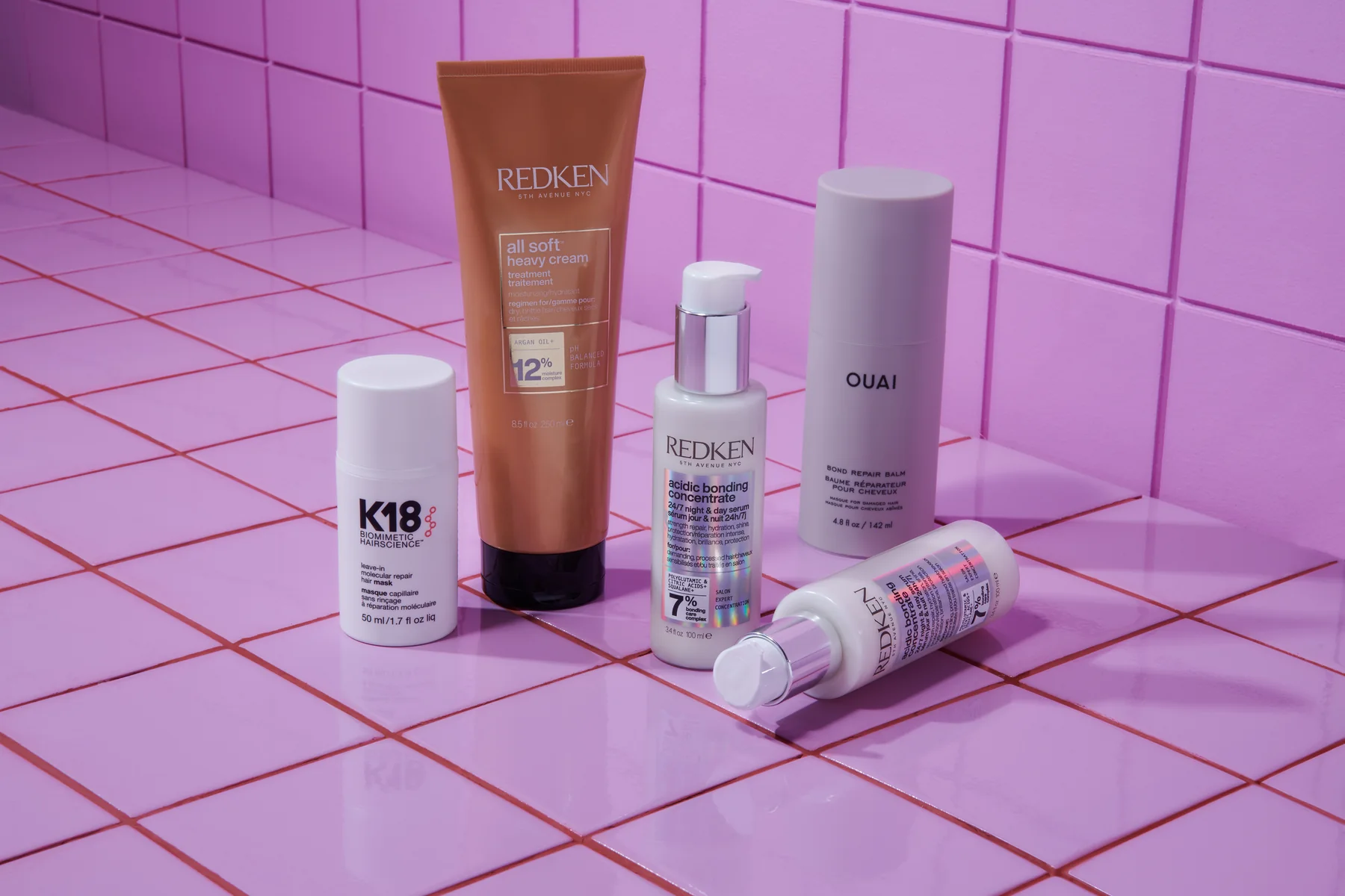 Sephora haircare tubes and bottles on a pink backdrop