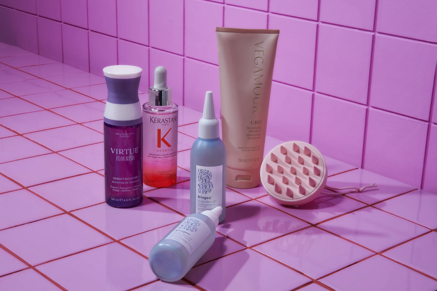 Sephora haircare products and a scalp brush on a pink backdrop