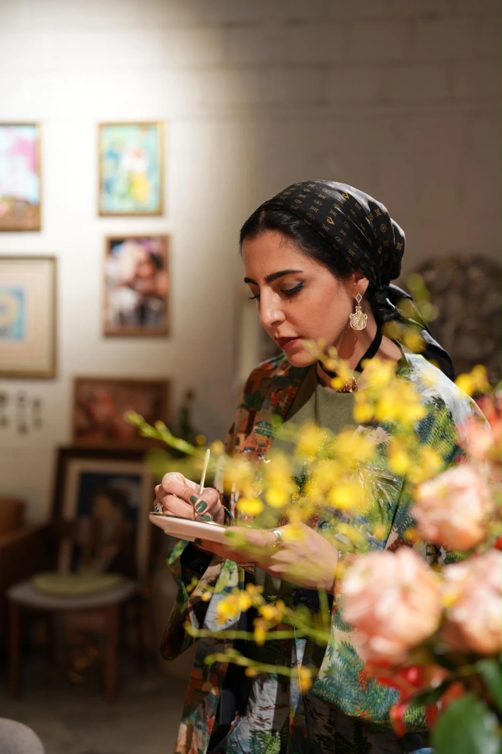 Farah Bastaki seated among native flowers