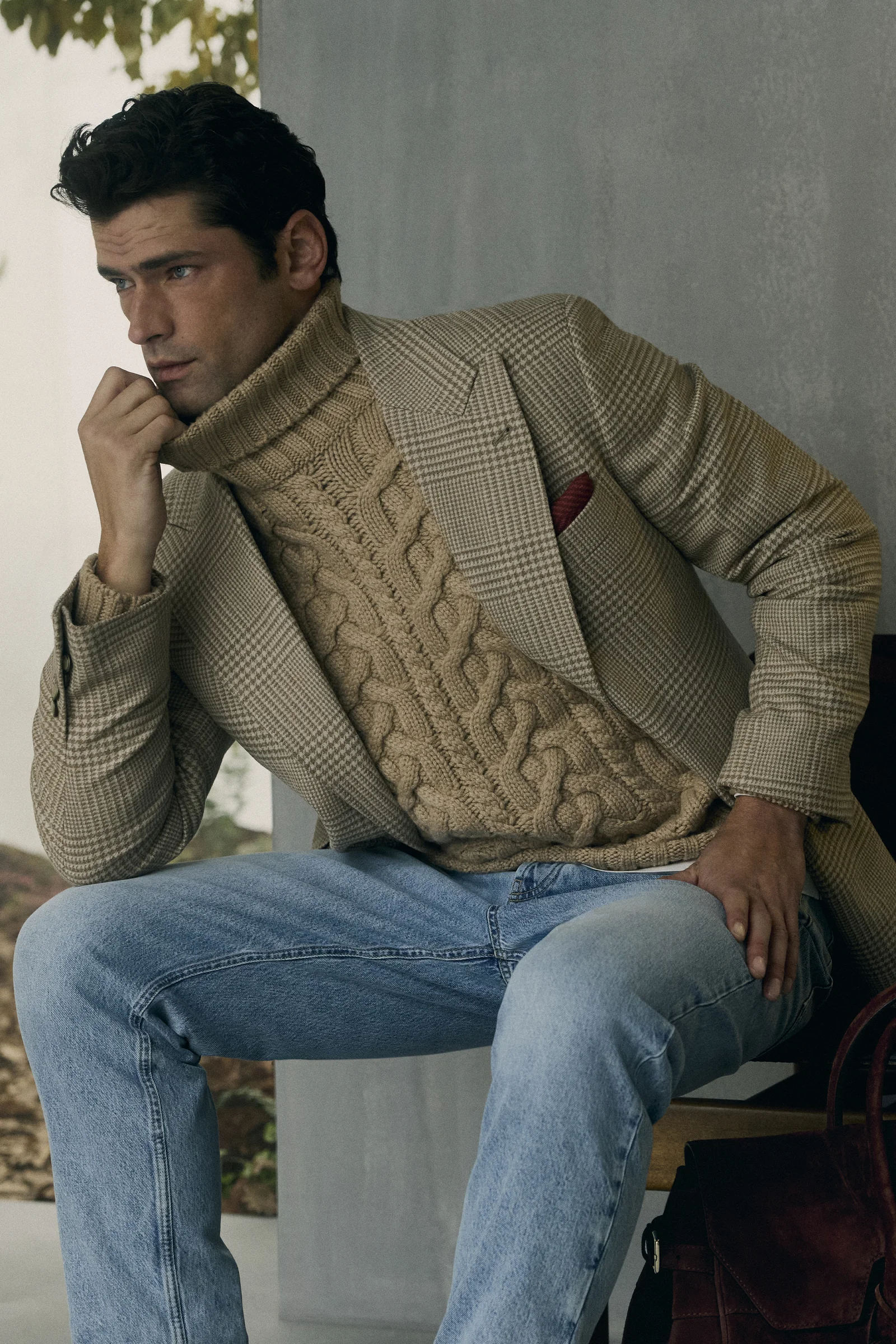 A Brunello Cucinelli cable-knit worn under a jacket with denim, Fall Winter 2026