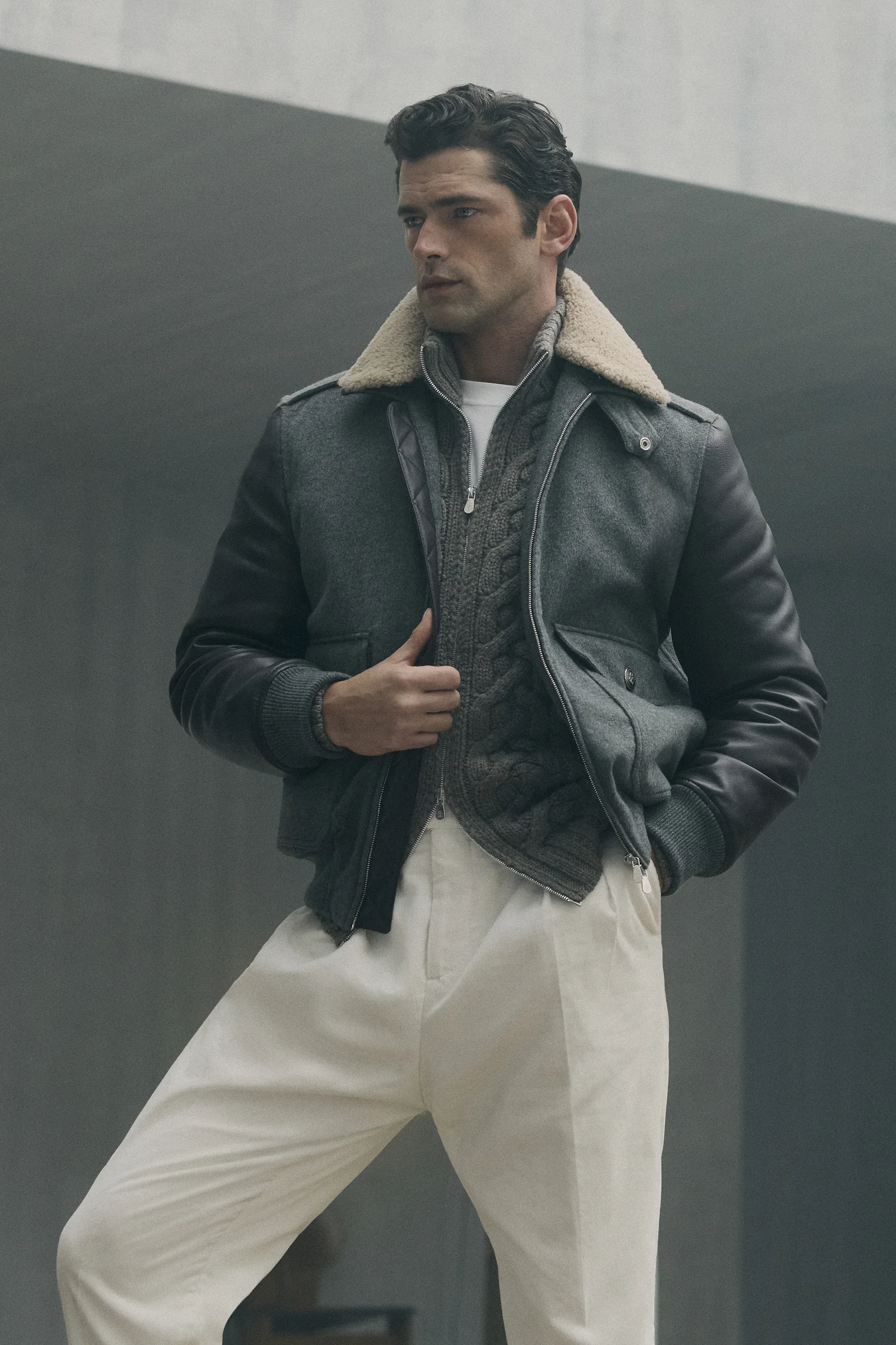 A Brunello Cucinelli shearling-collar leather bomber with white trousers, Fall Winter 2026