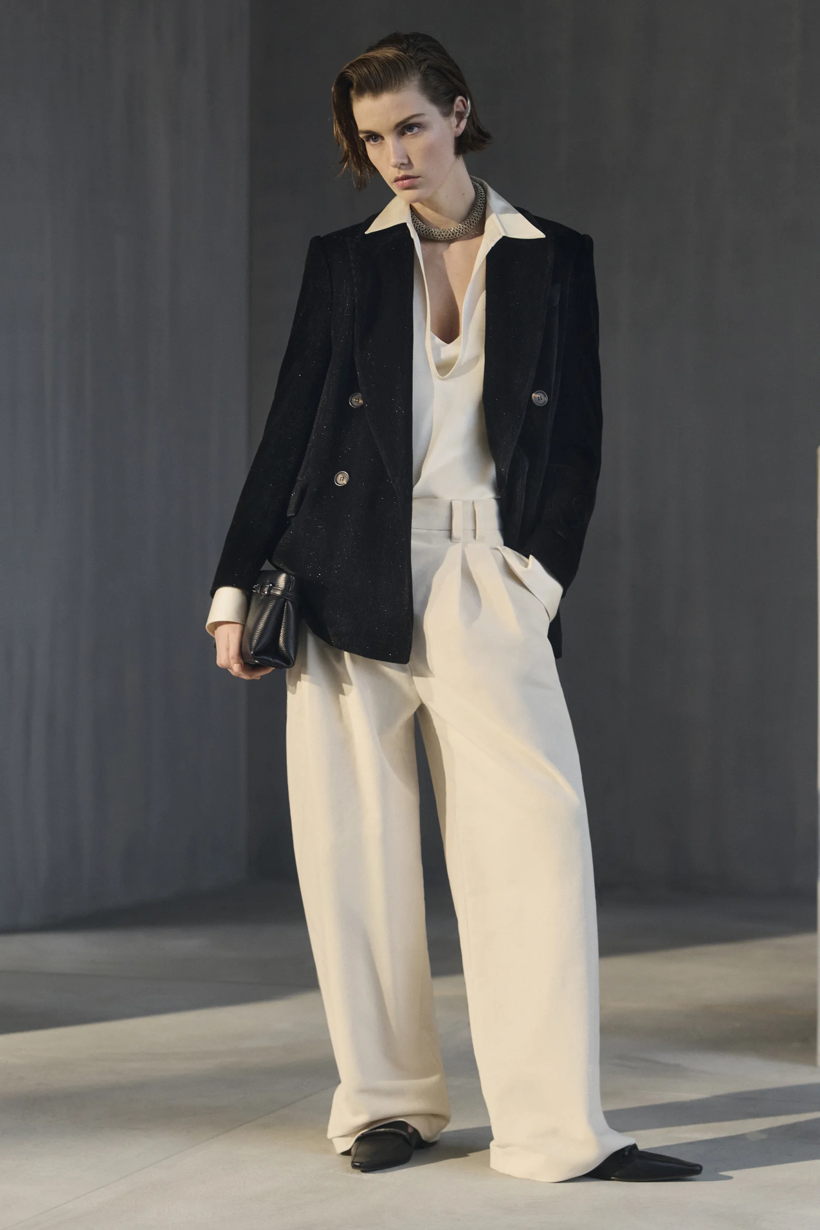 A Brunello Cucinelli velvet blazer with white wide-leg trousers for evening, Fall Winter 2026