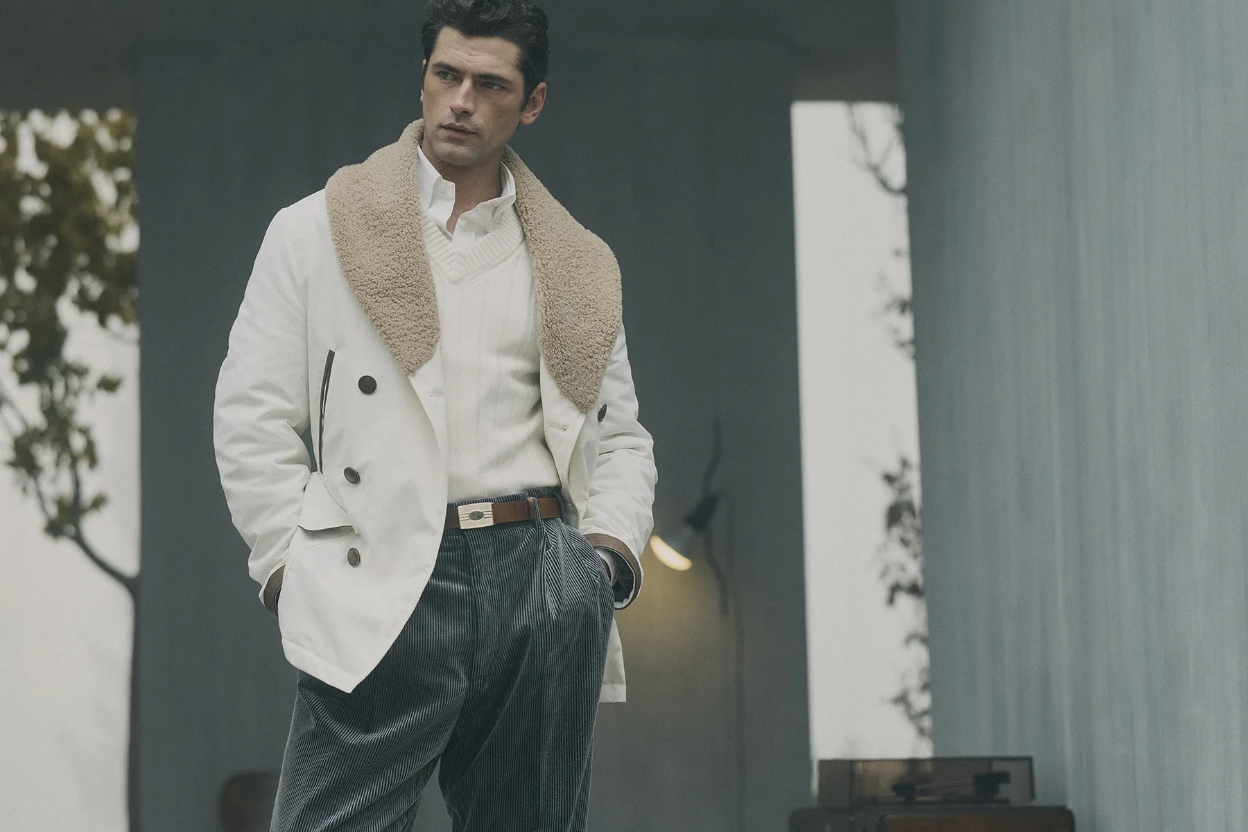 A model in a Brunello Cucinelli white shearling-collar coat, Fall Winter 2026