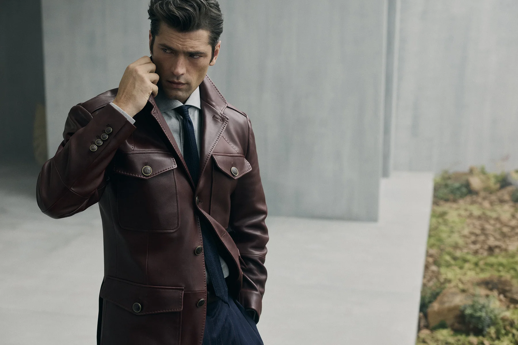 A model in a Brunello Cucinelli burgundy leather double-breasted coat, Fall Winter 2026