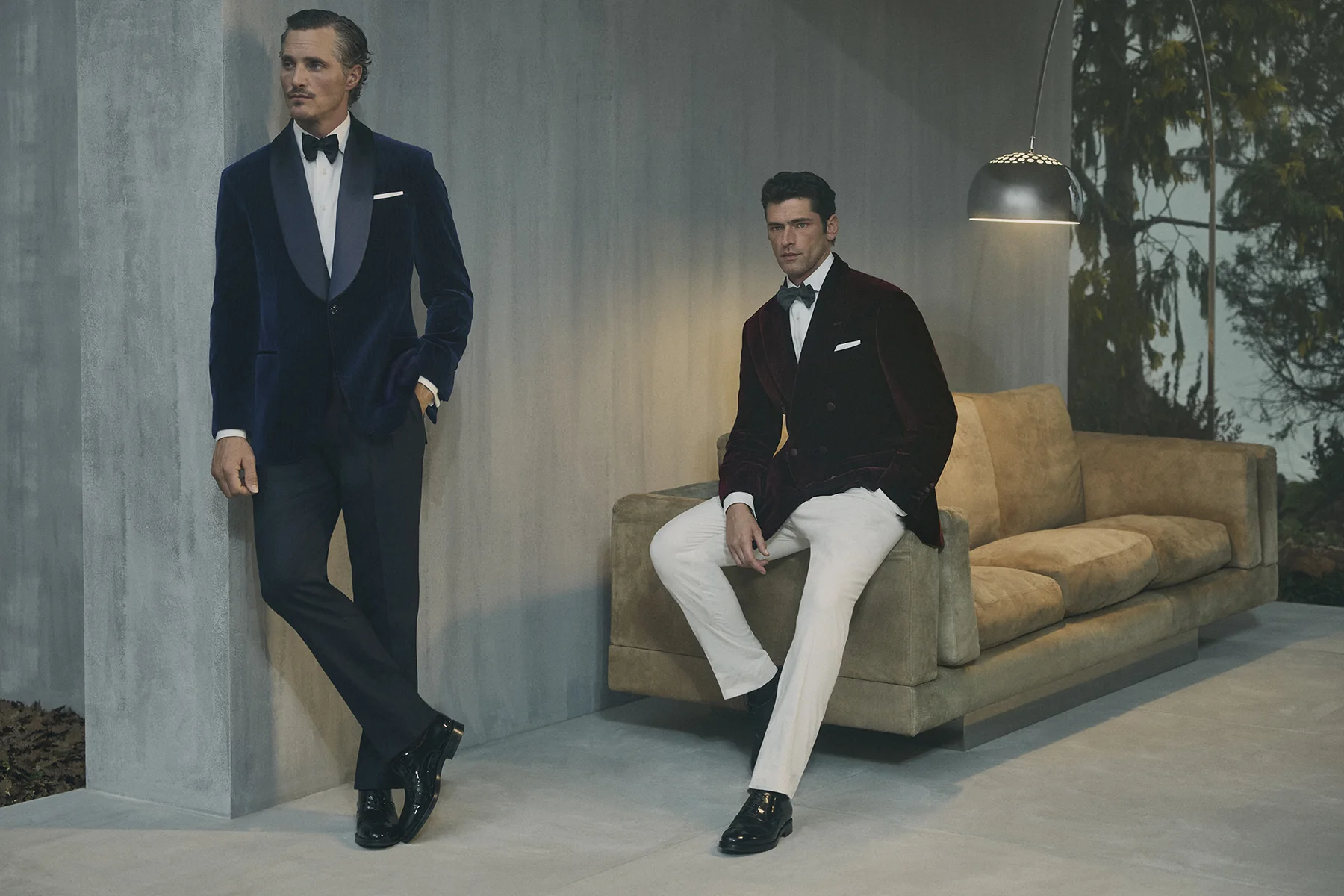 Two models in Brunello Cucinelli evening looks, a navy and a burgundy velvet dinner jacket, Fall Winter 2026