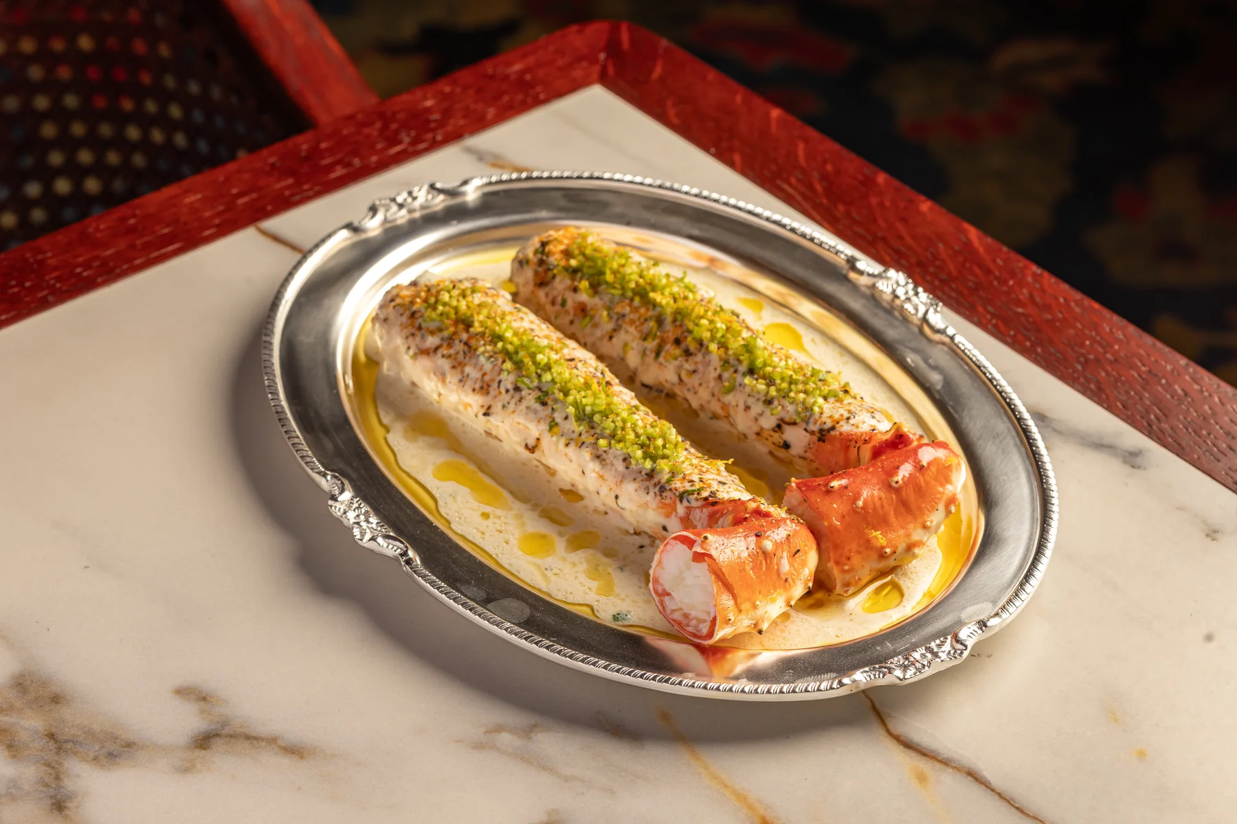 A signature dish plated on silver at Gymkhana Dubai