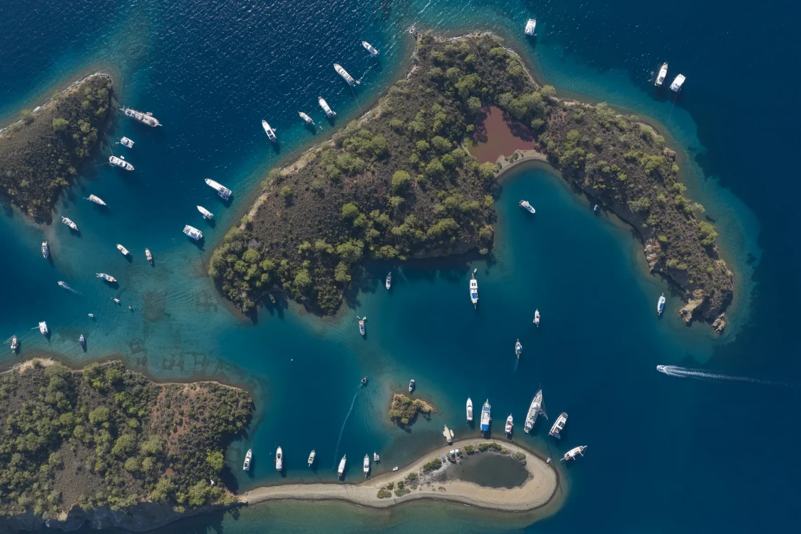 Aerial view of boats anchored in a turquoise Göcek bay on Türkiye's Turquoise Coast