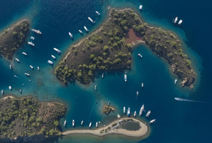 Aerial view of boats anchored in a turquoise Göcek bay on Türkiye's Turquoise Coast