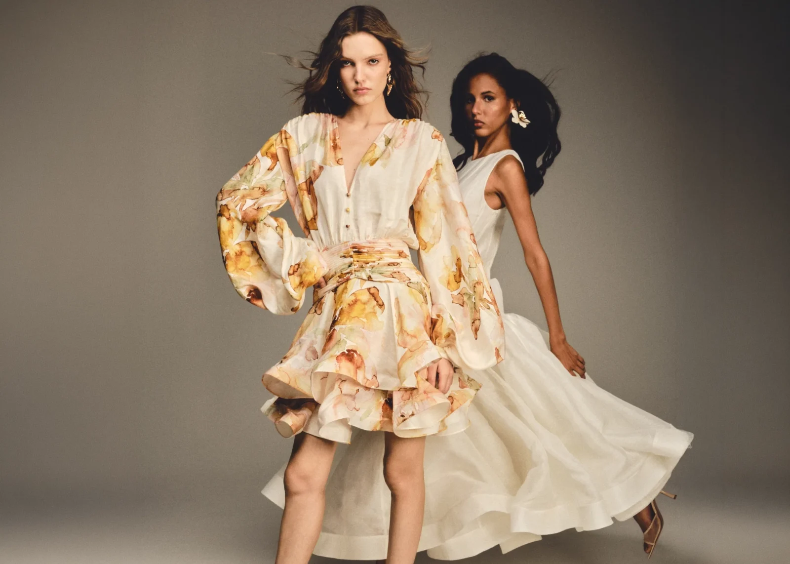 Two models in floral and ivory dresses from BY HAÓ's Jardins de la Cour collection