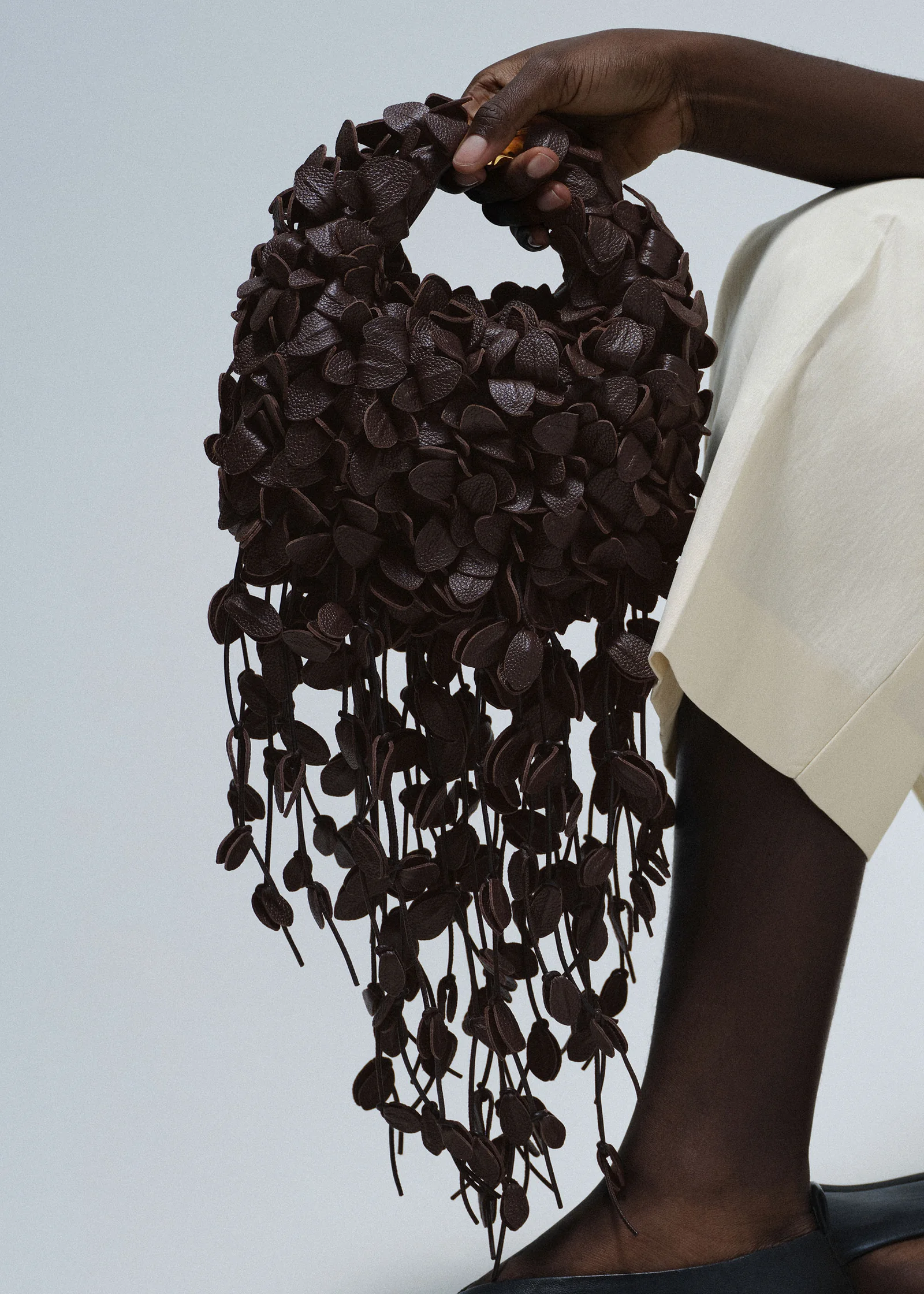 The Polene Beri Lif in Ebony, a deep near-black leather-leaf bag