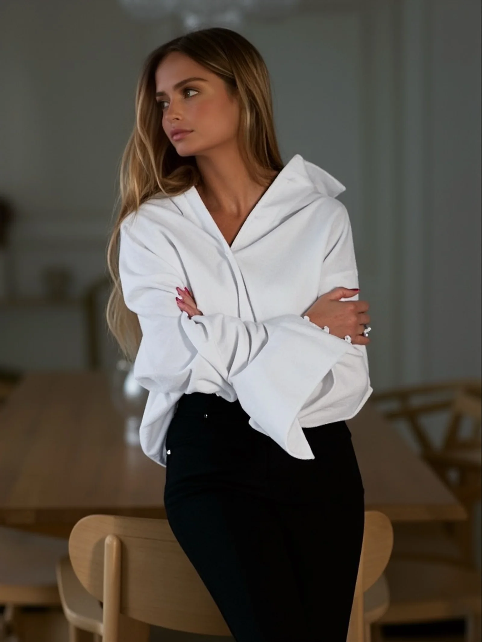 Shahad Albandar in a relaxed white shirt and dark skirt