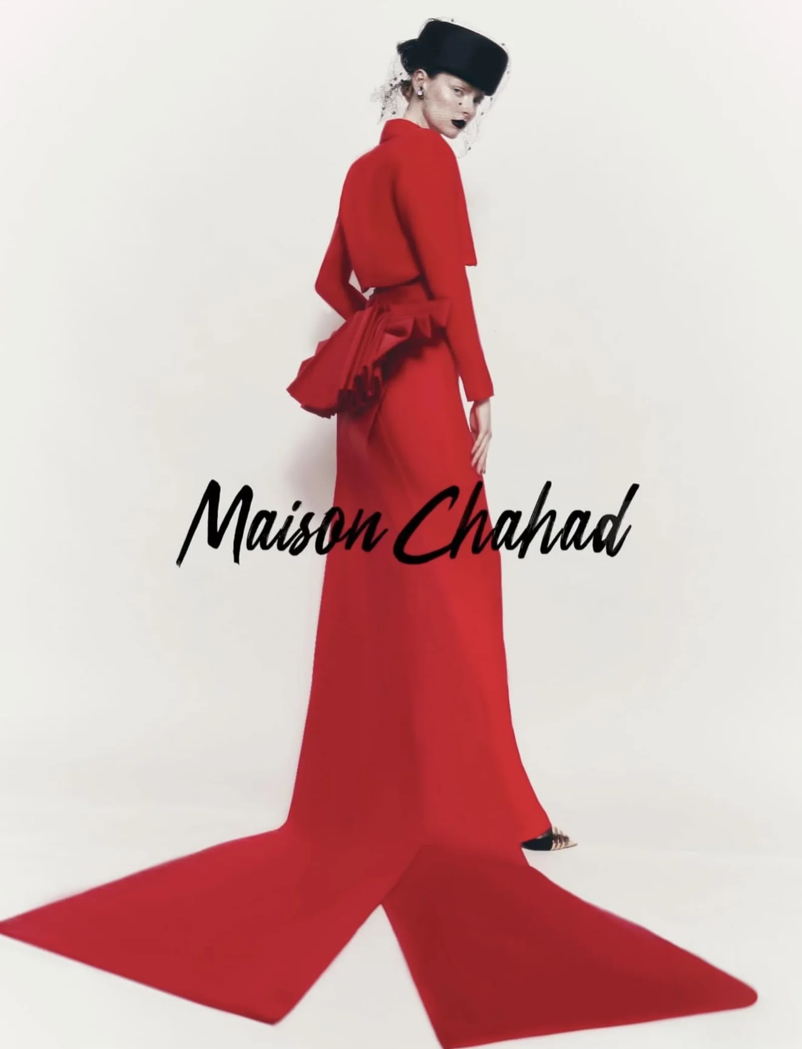 A sculptural red Maison Chahad gown with a dramatic train