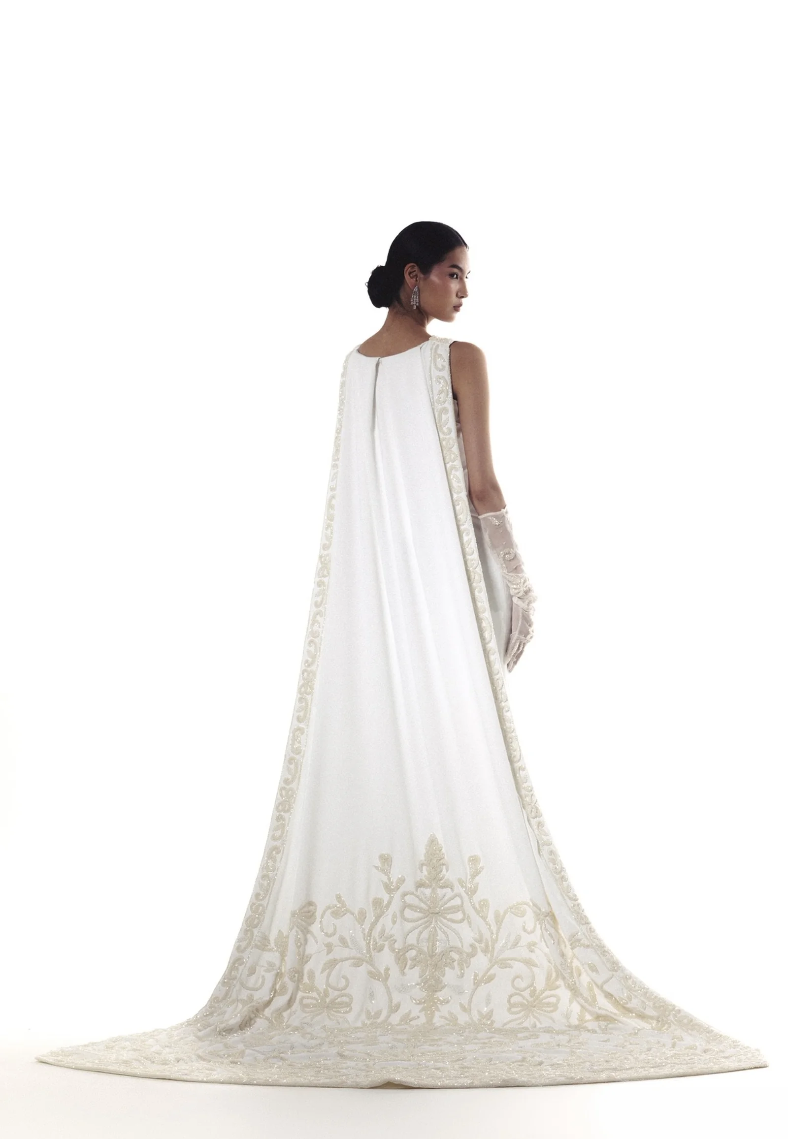 A white Maison Chahad gown with fine embroidery