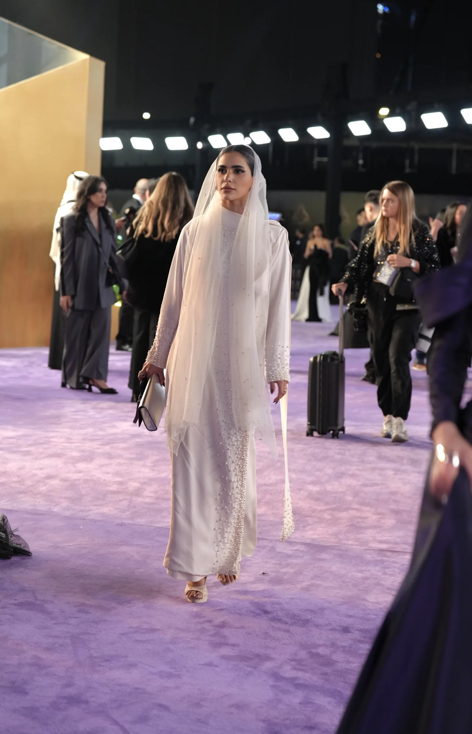 Daylal Al Hajeri in a cream gown at an event