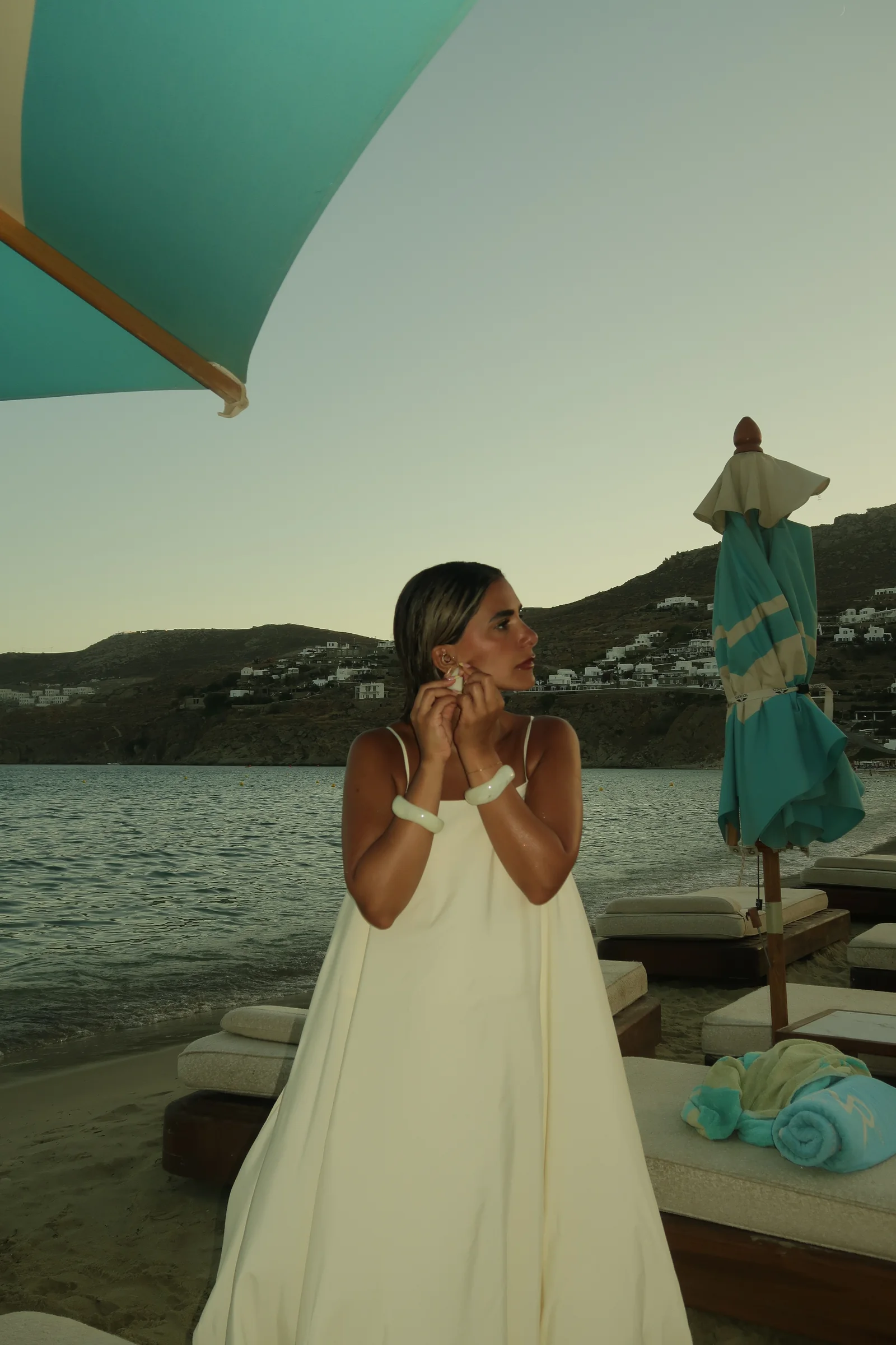 Daylal Al Hajeri in a light gown by the water