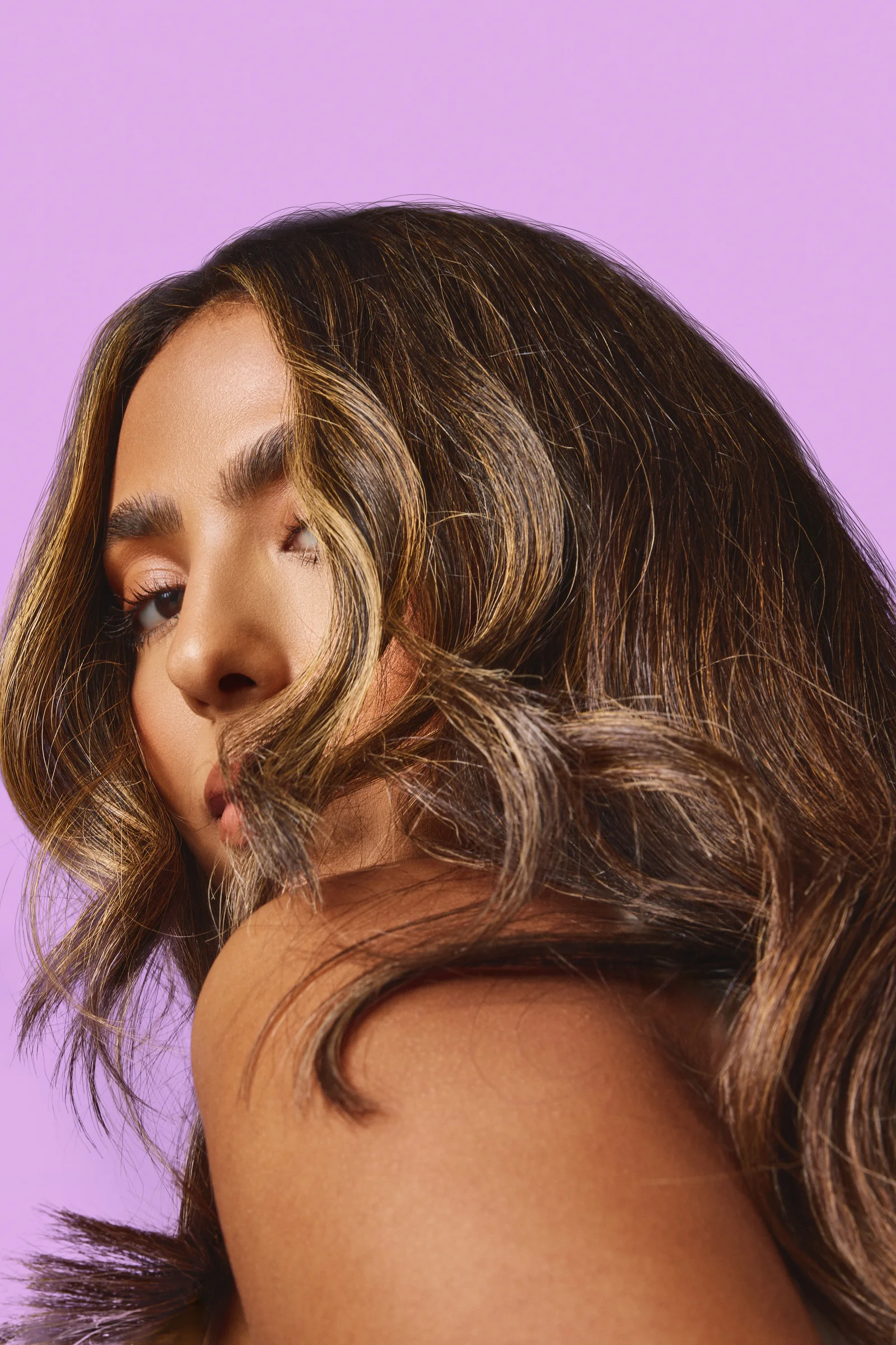 Model with wavy hair in warm light, Sephora haircare campaign