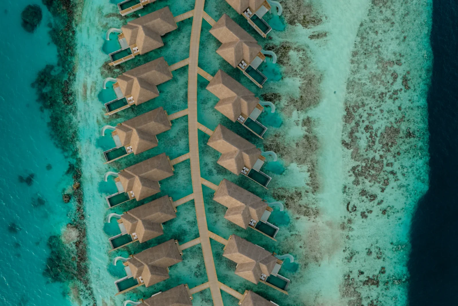 Aerial view of overwater villas at Sun Siyam Vilu Reef, Maldives