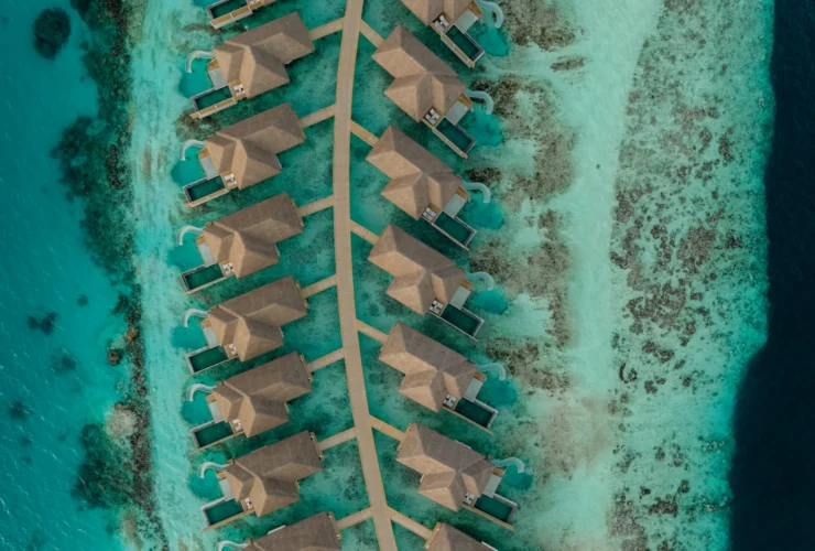 Aerial view of overwater villas at Sun Siyam Vilu Reef, Maldives