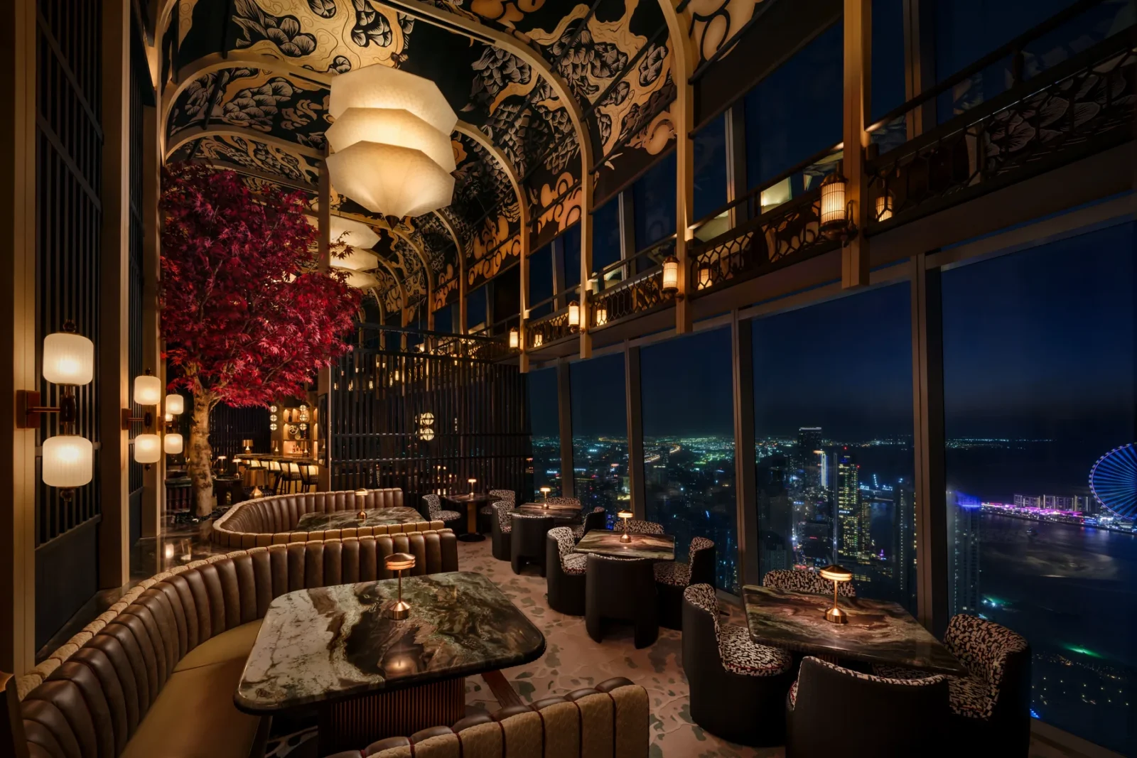 The suspended cherry blossom tree at TATTU Restaurant and Bar, Level 74, with the Dubai Marina skyline beyond