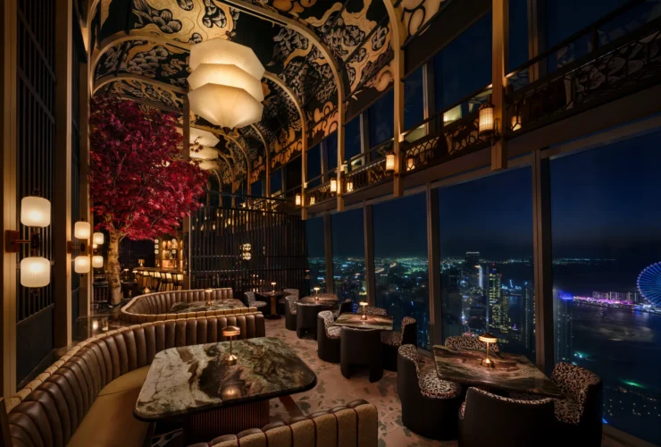 The suspended cherry blossom tree at TATTU Restaurant and Bar, Level 74, with the Dubai Marina skyline beyond