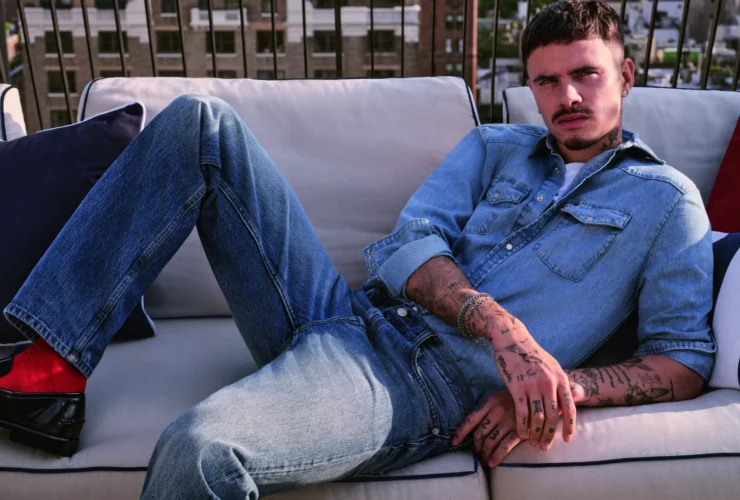 Romeo Beckham in a Tommy Hilfiger denim shirt and straight-leg jeans on a New York rooftop