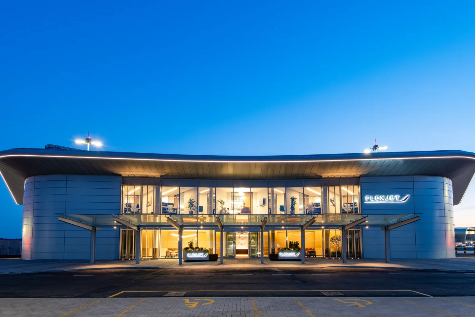 Flexjet's private terminal at Farnborough Airport lit at dusk